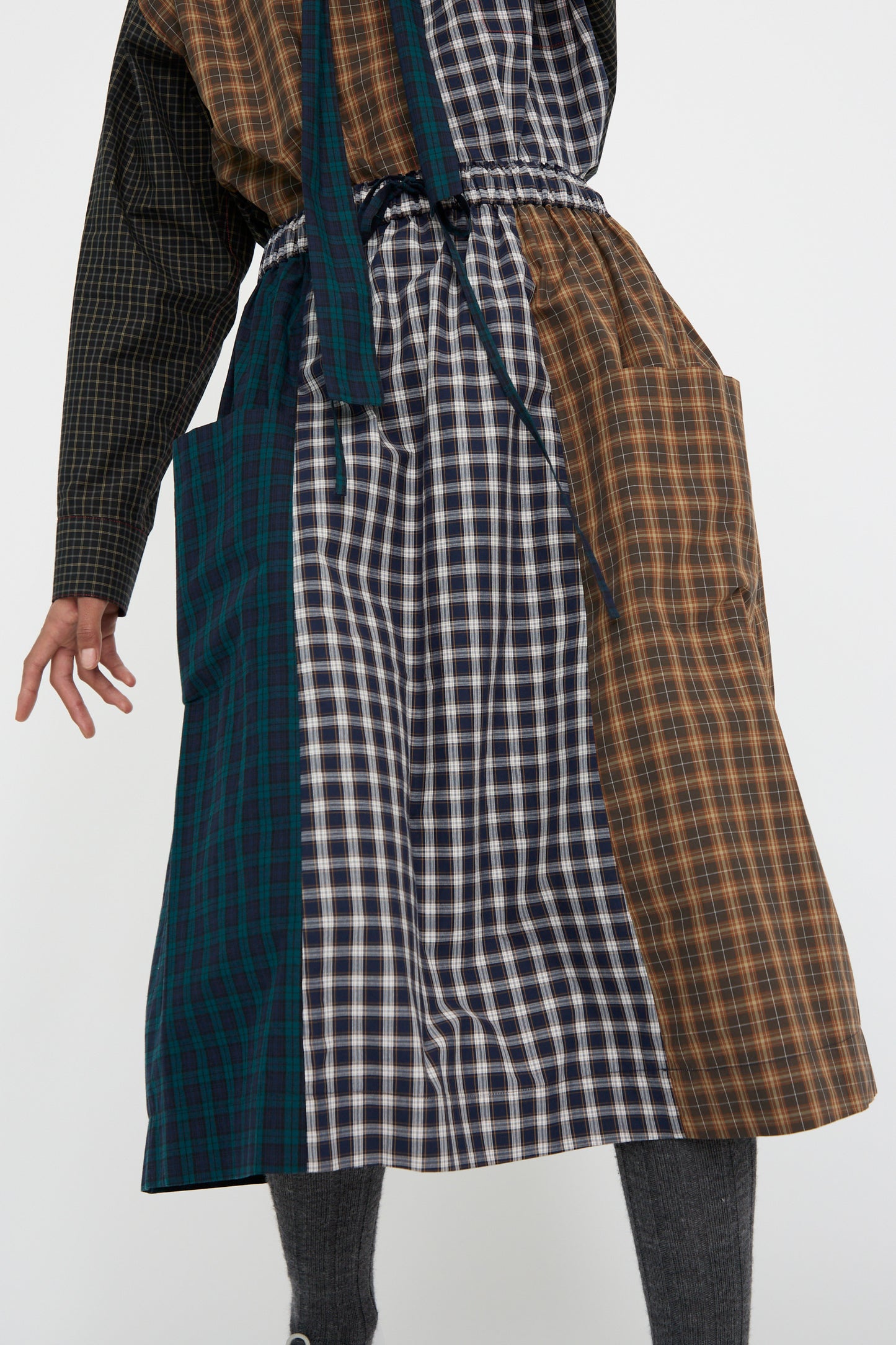 A person dressed in a Heavy Poplin Skirt by KasMaria, showcasing a mix of plaid designs.