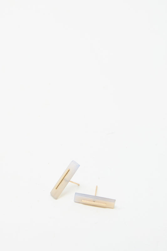 Two 14K yellow gold rectangular earrings styled with a minimalist touch are set against a plain white background. 