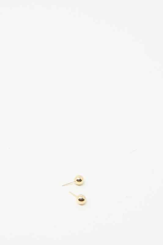 Kathleen Whitaker's 14K Yellow Gold Sphere Stud Small 6mm earrings offer an elegant, precise design featuring two small hollow spheres on a white background.