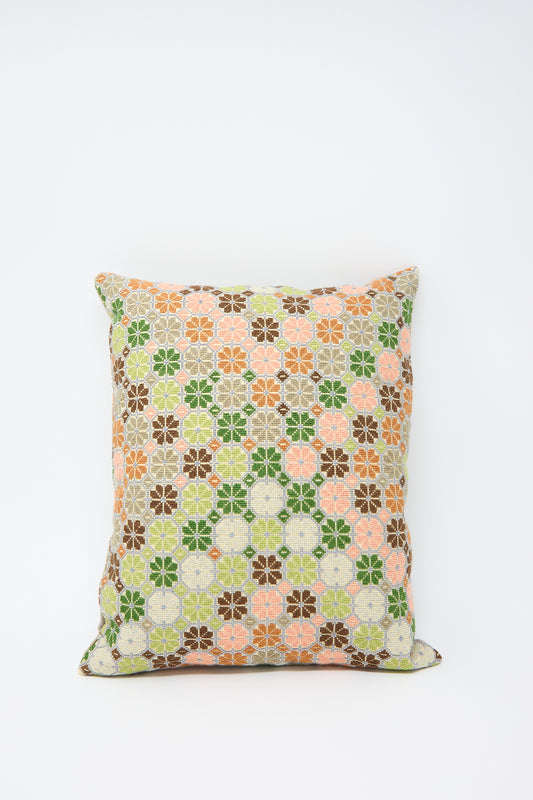 A Kissweh Damask Rose Hand Embroidered Pillow in Coral and Olive, a one-of-a-kind rectangular pillow with a floral pattern in green, orange, brown, and white on a white background, crafted from fine Libeco Belgian linen.