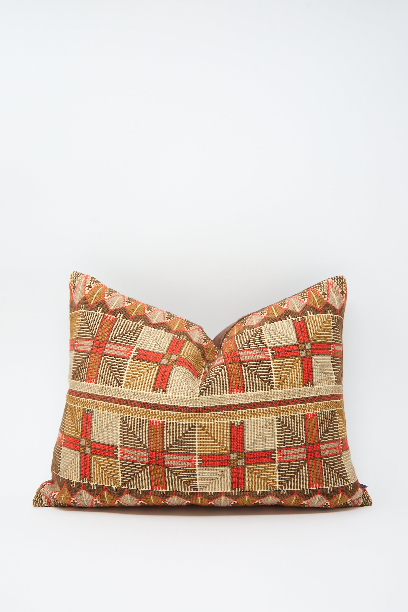 The Ensaf Hand Embroidered Pillow in Chocolate from Kissweh, crafted from luxurious Belgian linen, features a geometric pattern in shades of red, gold, and beige against a plain white background.