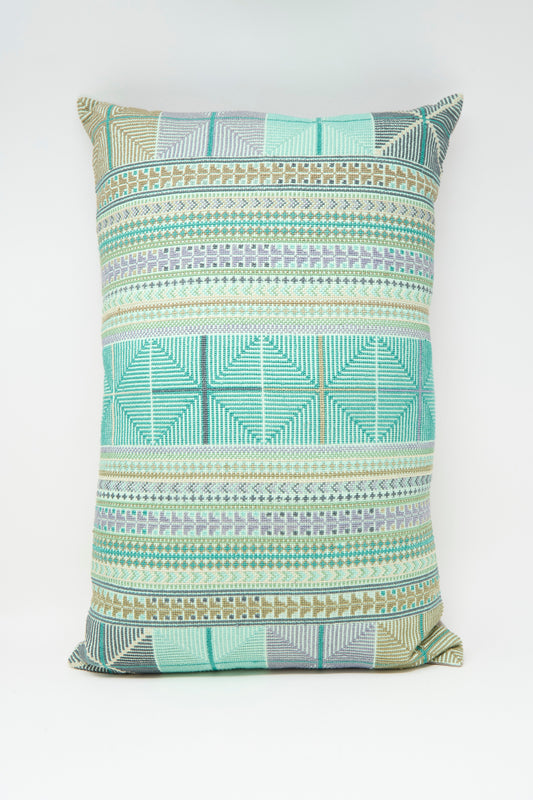 The Hanan Hand Embroidered Pillow in Acqua I by Kissweh features a geometric design in green, blue, and beige on white Belgian linen, and includes a plush down feather insert for extra comfort.