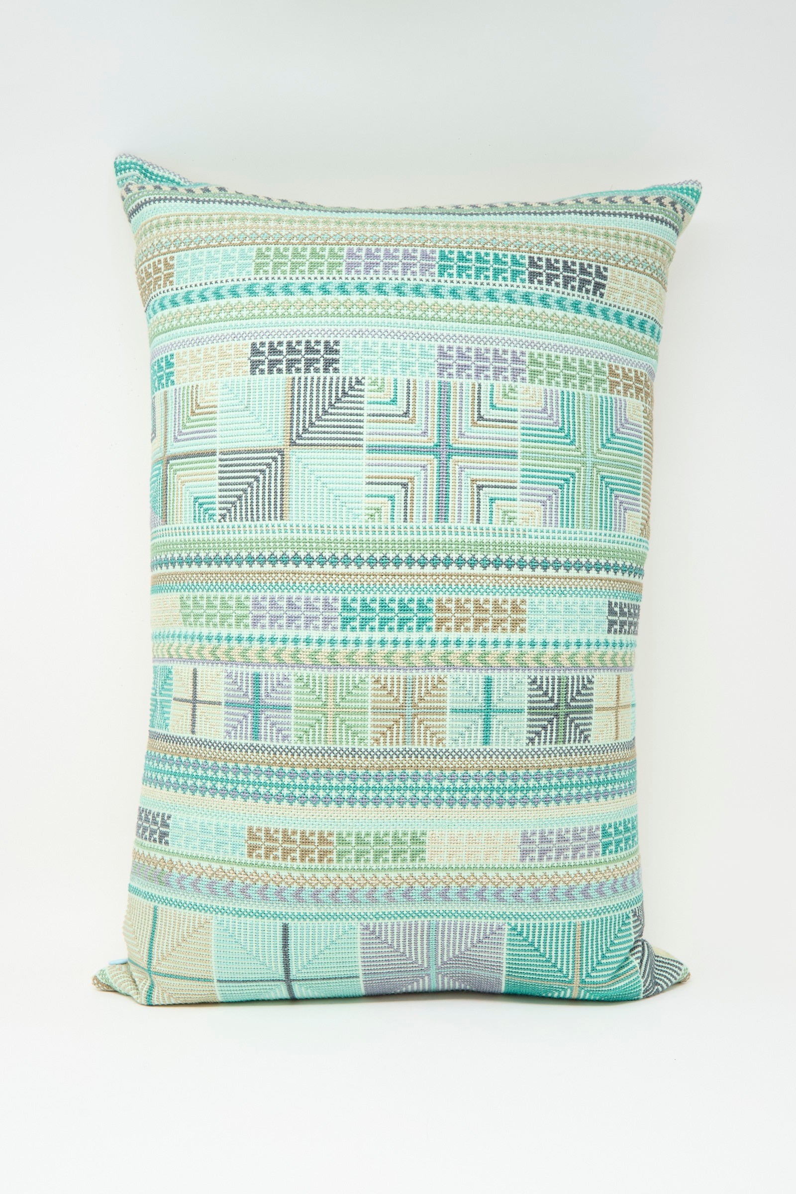 The Hanan Hand Embroidered Pillow in Acqua II by Kissweh features a geometric pattern in green, blue, beige, and gray Belgian linen with a plush down feather insert for comfort. Displayed on a plain white background.