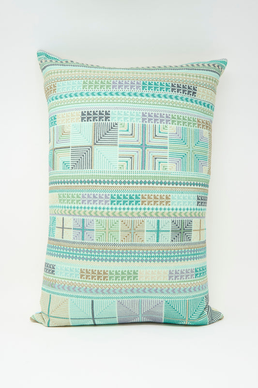 The Hanan Hand Embroidered Pillow in Acqua II by Kissweh features a geometric pattern in green, blue, beige, and gray Belgian linen with a plush down feather insert for comfort. Displayed on a plain white background.