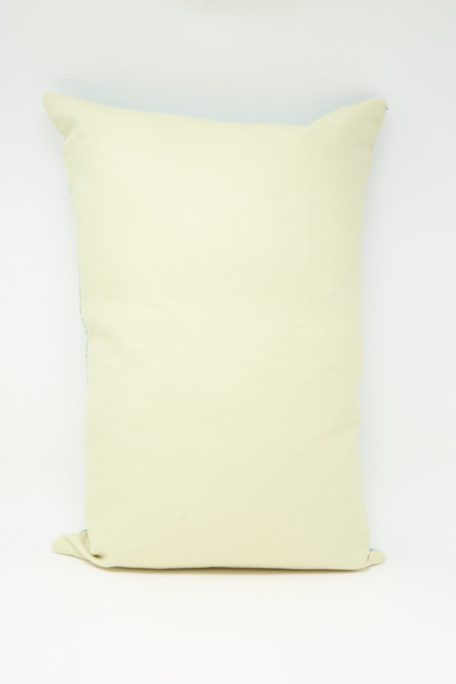 The Hanan Hand Embroidered Pillow in Acqua II by Kissweh, featuring a rectangular shape and intricate detailing, is displayed standing upright against a white background.