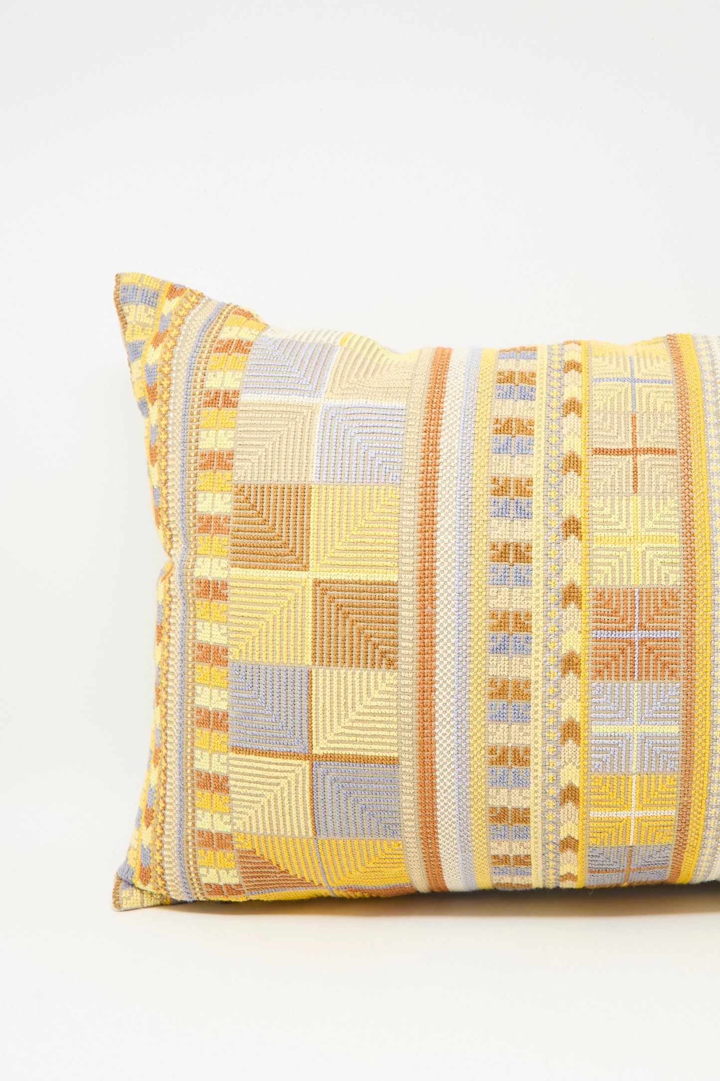 The Hanan Hand Embroidered Pillow in Mustard by Kissweh features a striking geometric pattern, adding modern flair to any space.