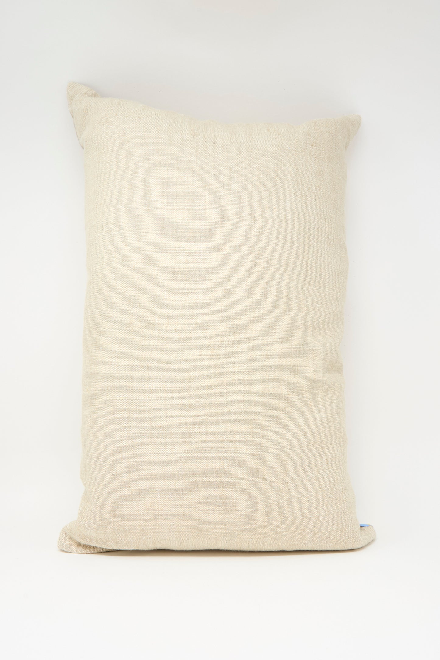 The Imm Bushra Hand Embroidered Pillow in Mustard by Kissweh, featuring textured Belgian linen, stands upright against a plain white background.