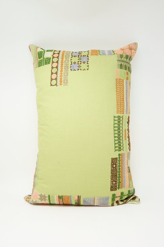 The Kissweh Imm Bushra Hand Embroidered Pillow in Olive is a rectangular Belgian linen pillow featuring multicolored edge embroidery, shown against a plain white background.