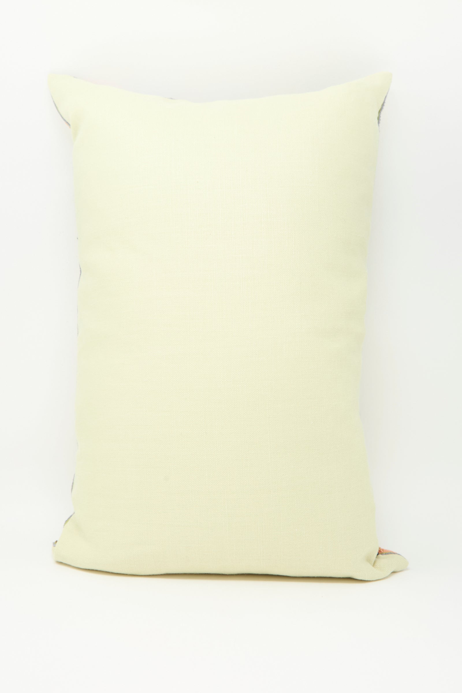 The Imm Bushra Hand Embroidered Pillow in Olive by Kissweh is propped upright against a plain white background.