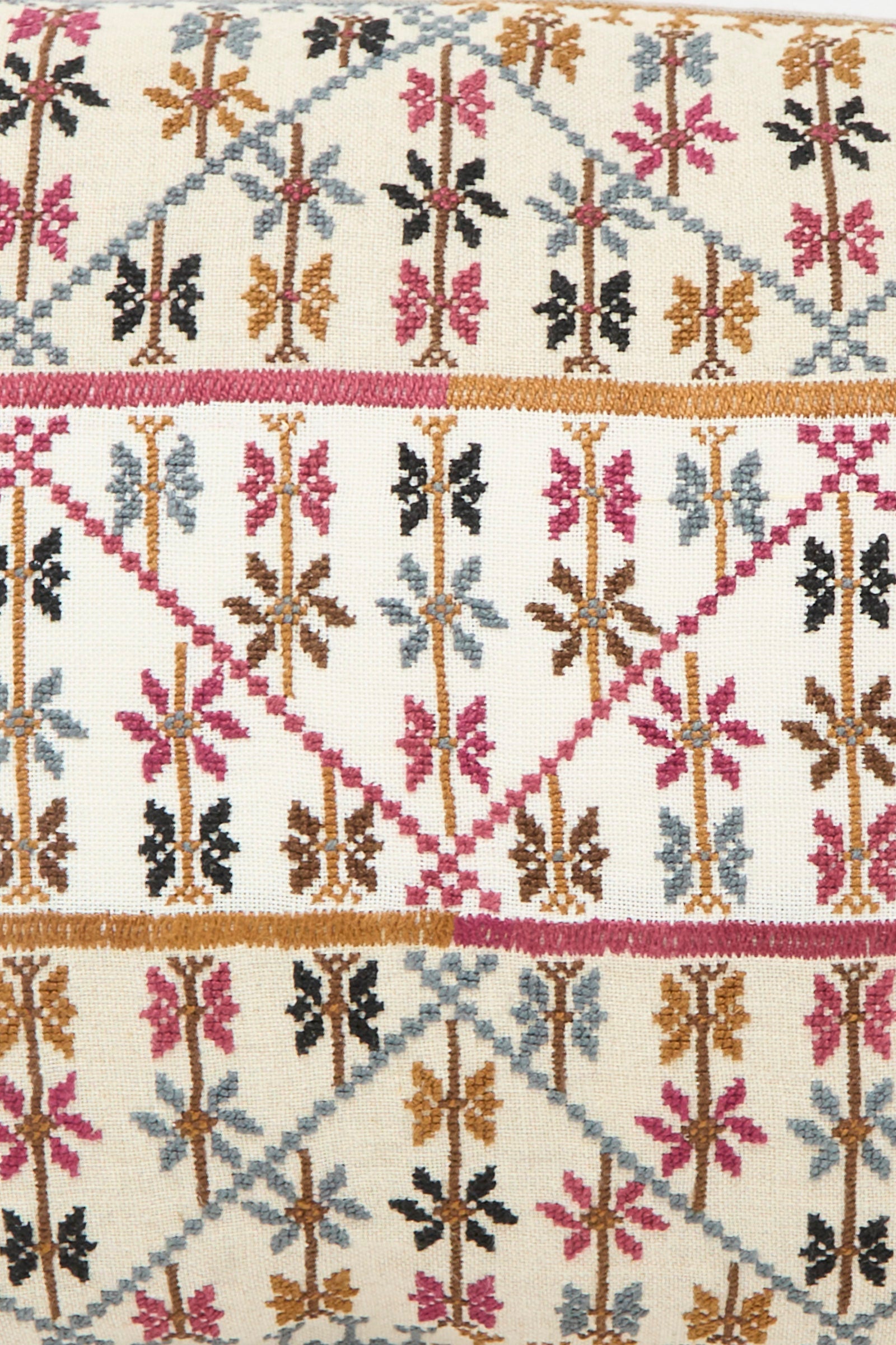 The Kissweh Imm Omar Hand Embroidered Pillow in Beige and Chocolate features geometric patterns in brown, pink, black, and blue on a cream background—crafted from luxurious Libeco Belgian linen for a refined accent.