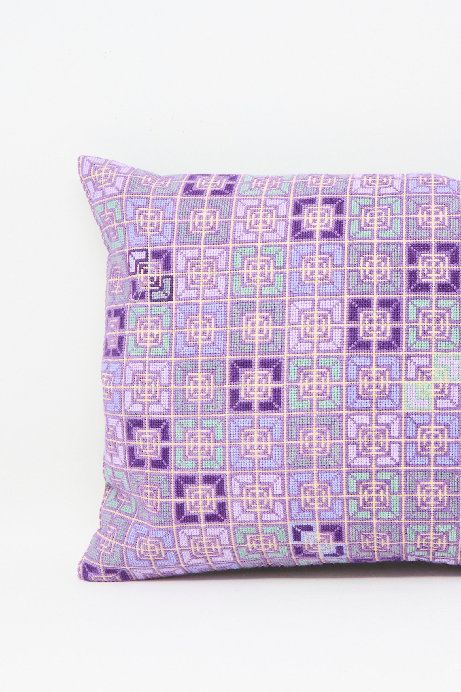 The Kissweh Rana Hand Embroidered Pillow in Lilac and Purple II features a geometric Belgian linen design in purple, green, and white, displayed against a plain white background.