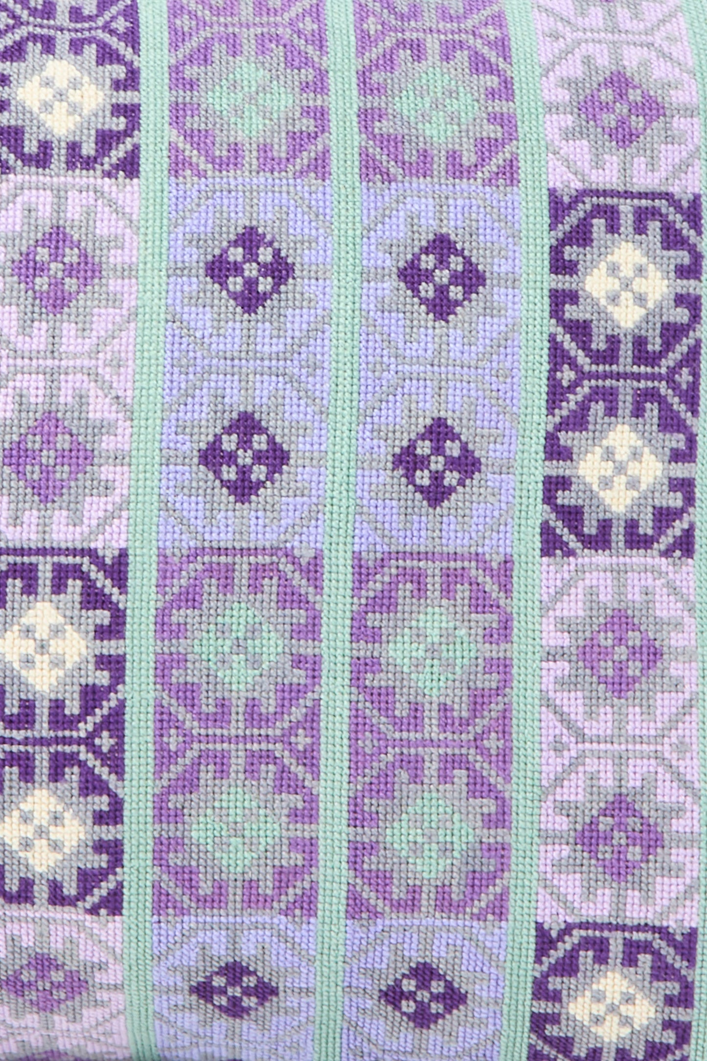 The Wafa'a Hand Embroidered Pillow in Lilac by Kissweh features alternating vertical stripes in purple, lavender, green, and cream on Libeco Belgian linen—ideal for adding artisanal style to your space.