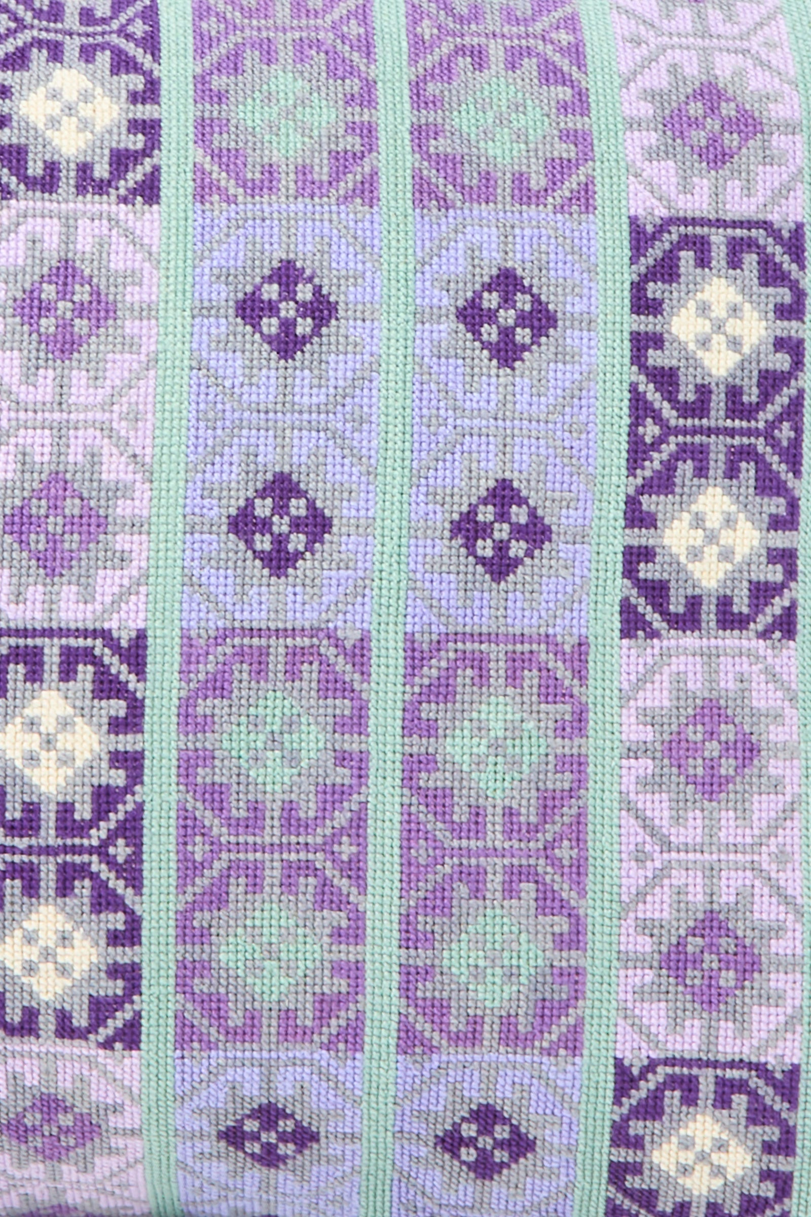 The Wafa'a Hand Embroidered Pillow in Lilac by Kissweh features alternating vertical stripes in purple, lavender, green, and cream on Libeco Belgian linen—ideal for adding artisanal style to your space.