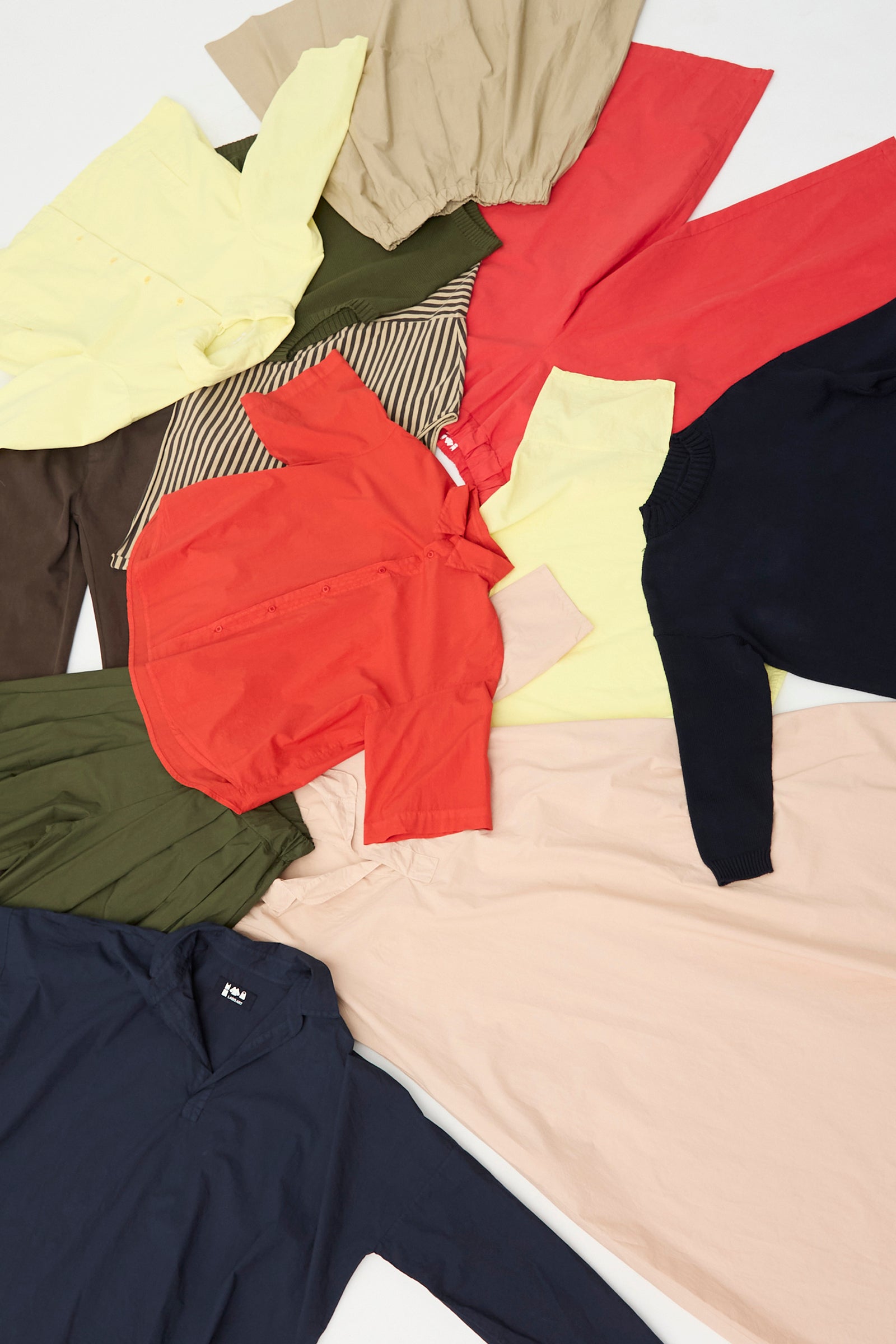 Pieces of the Labo.Art SS26 collection scattered on the white floor.