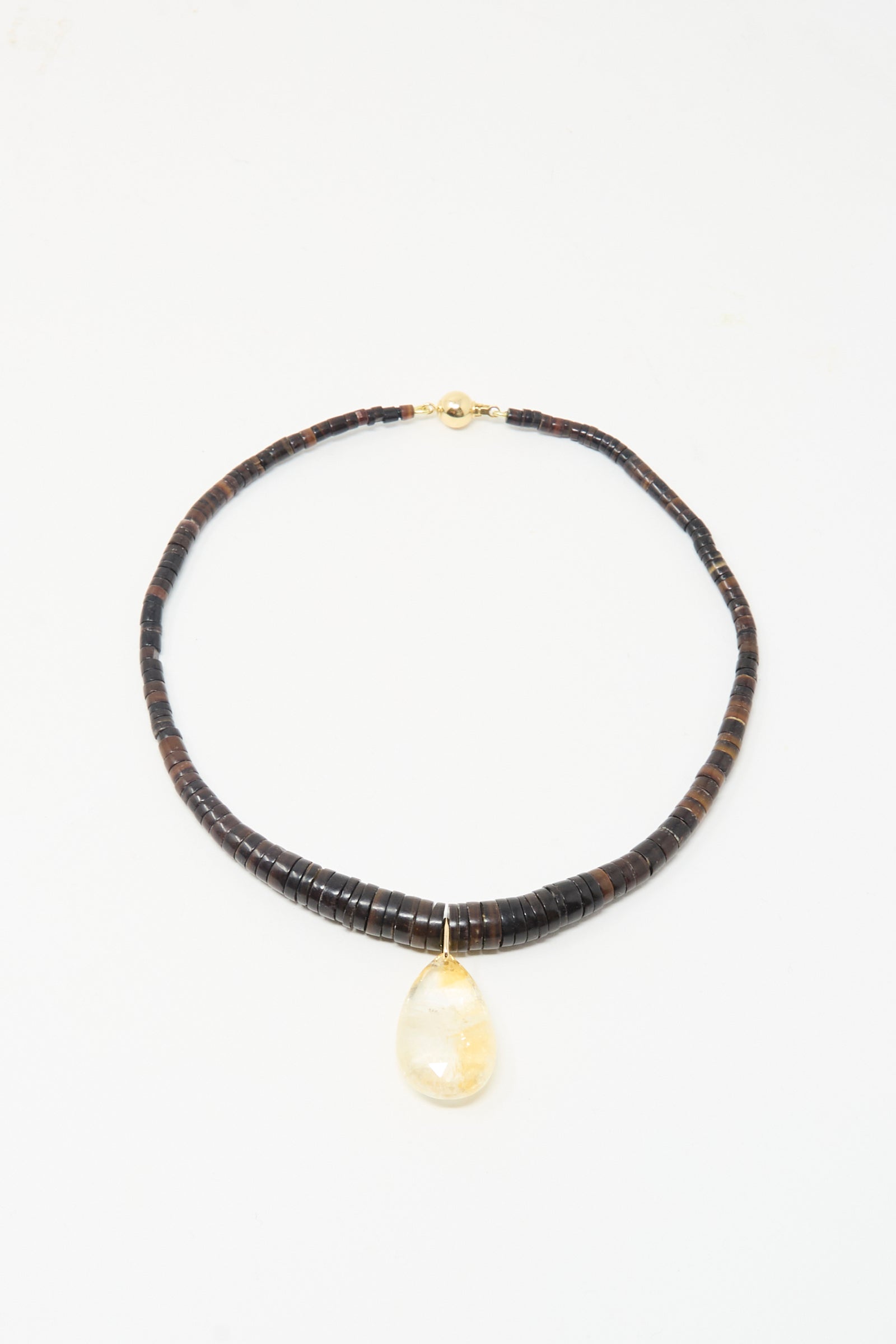 The Drop Collar in Citrine by Laoli features dark, round citrine beads and a large teardrop yellow pendant. Handmade in Paris, it is displayed against a white background.