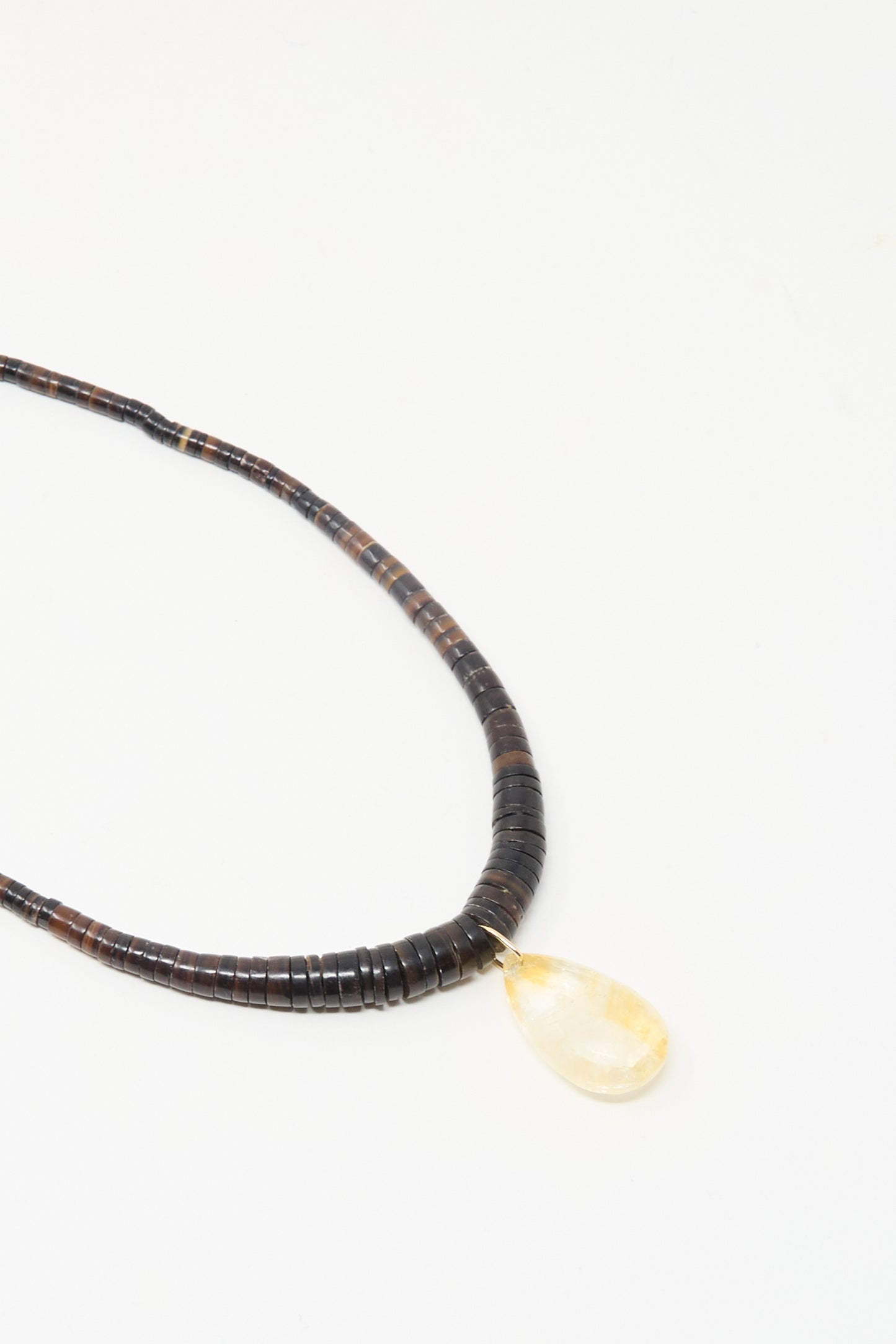 The Drop Collar in Citrine by Laoli is a handmade Parisian necklace with dark round beads and a single teardrop citrine pendant, shown on a white background.