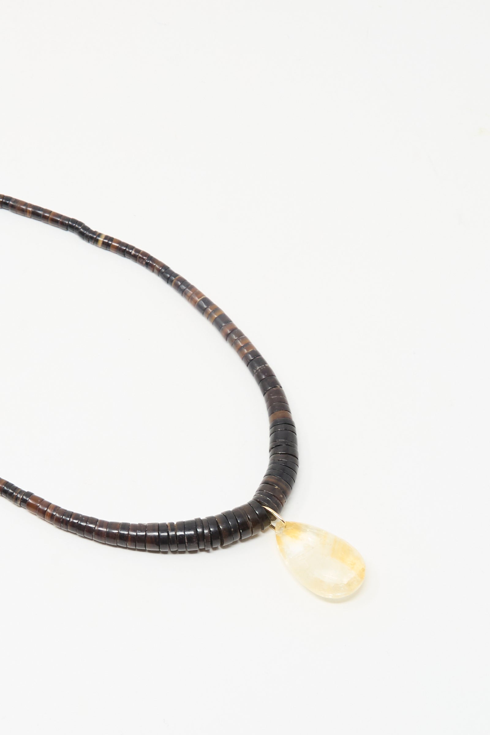 The Drop Collar in Citrine by Laoli is a handmade Parisian necklace with dark round beads and a single teardrop citrine pendant, shown on a white background.