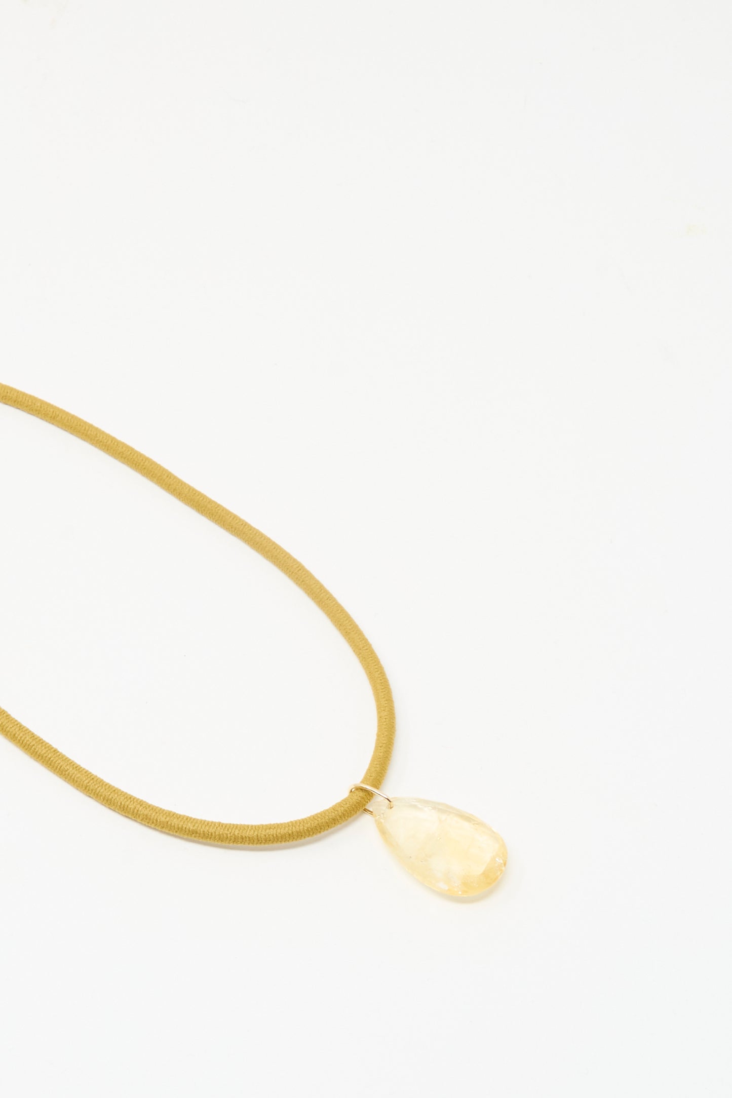 The Drop Cord in Tan and Citrine by Laoli features a teardrop-shaped yellow gemstone pendant on an 18k yellow gold chain, displayed against a plain white background.
