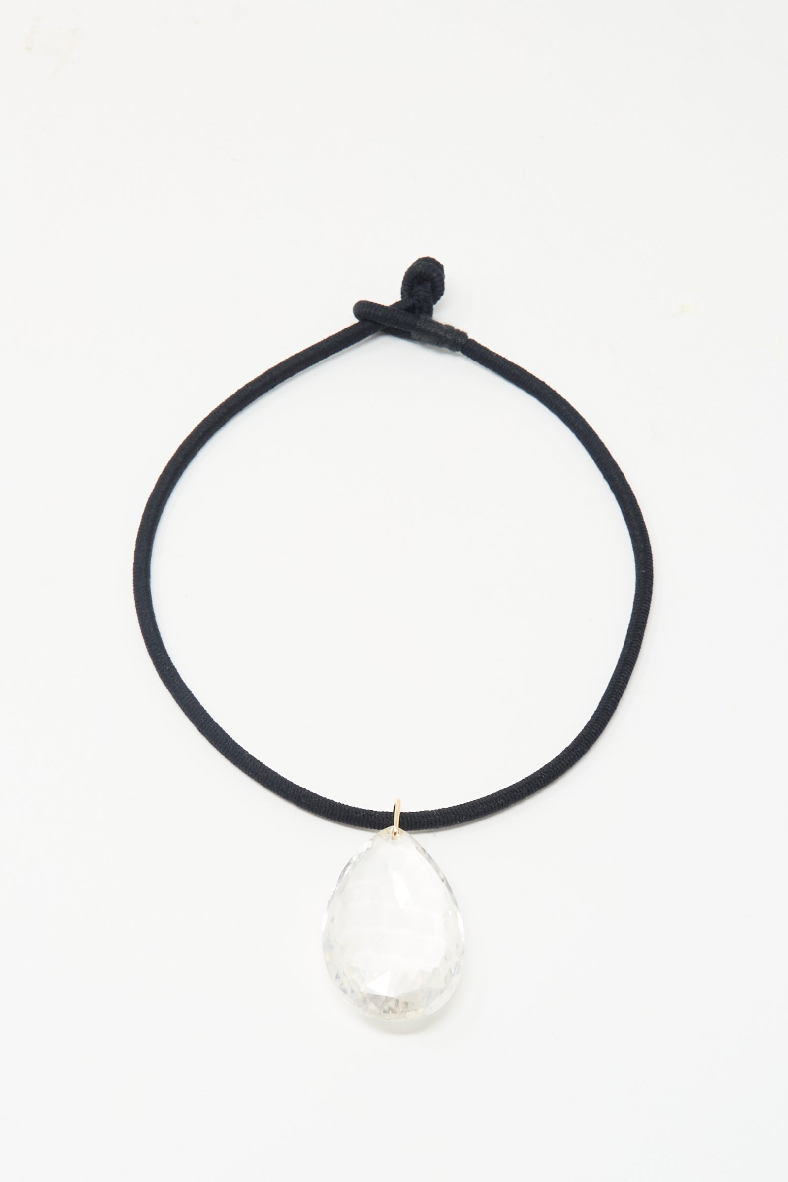 The Grande Drop in Black Cord and Quartz by Laoli: a handmade, 150-carat faceted clear rock crystal teardrop pendant on black cord, shown on a white background.