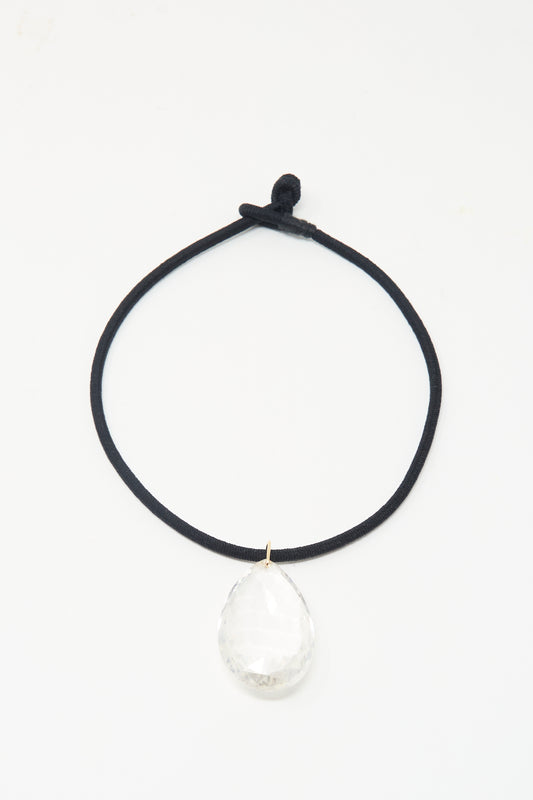 The Grande Drop in Black Cord and Quartz by Laoli: a handmade, 150-carat faceted clear rock crystal teardrop pendant on black cord, shown on a white background.