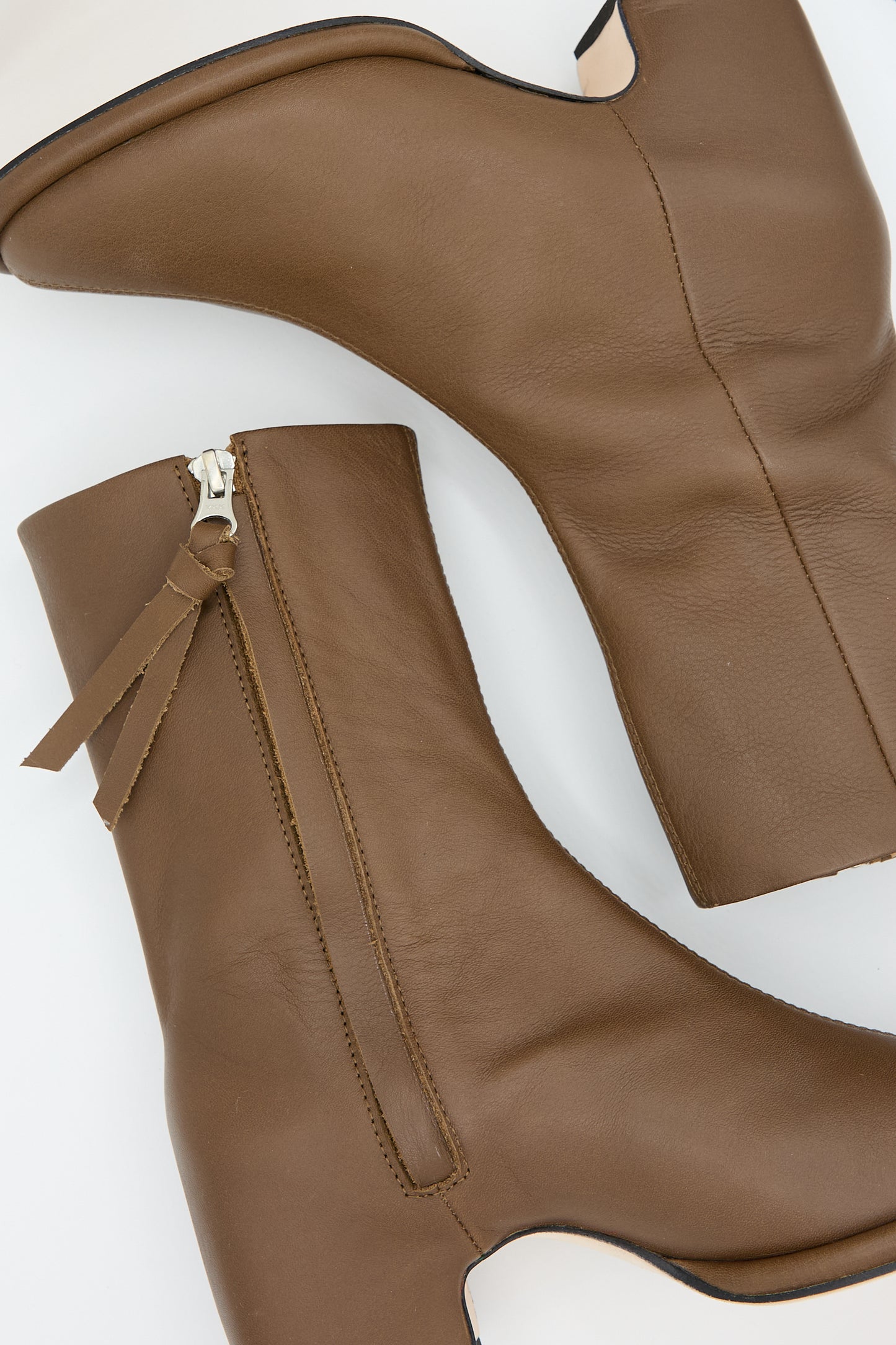 Lauren Manoogian's Arch Boot in Brown features expertly handcrafted brown leather ankle boots, complete with side zip closure and low block heels, captured beautifully on a white background.