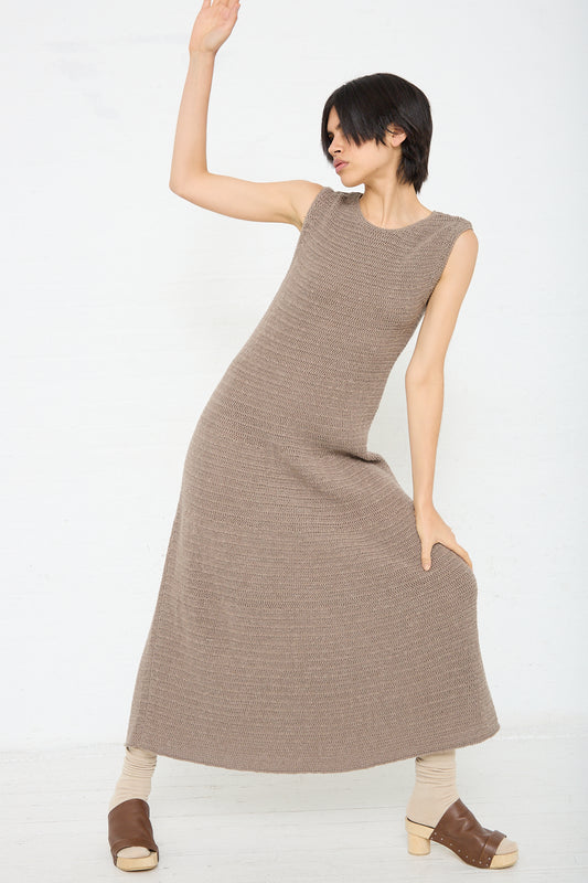 A woman is posing in a Lauren Manoogian Basket Dress in Wood (Brown). Front view.