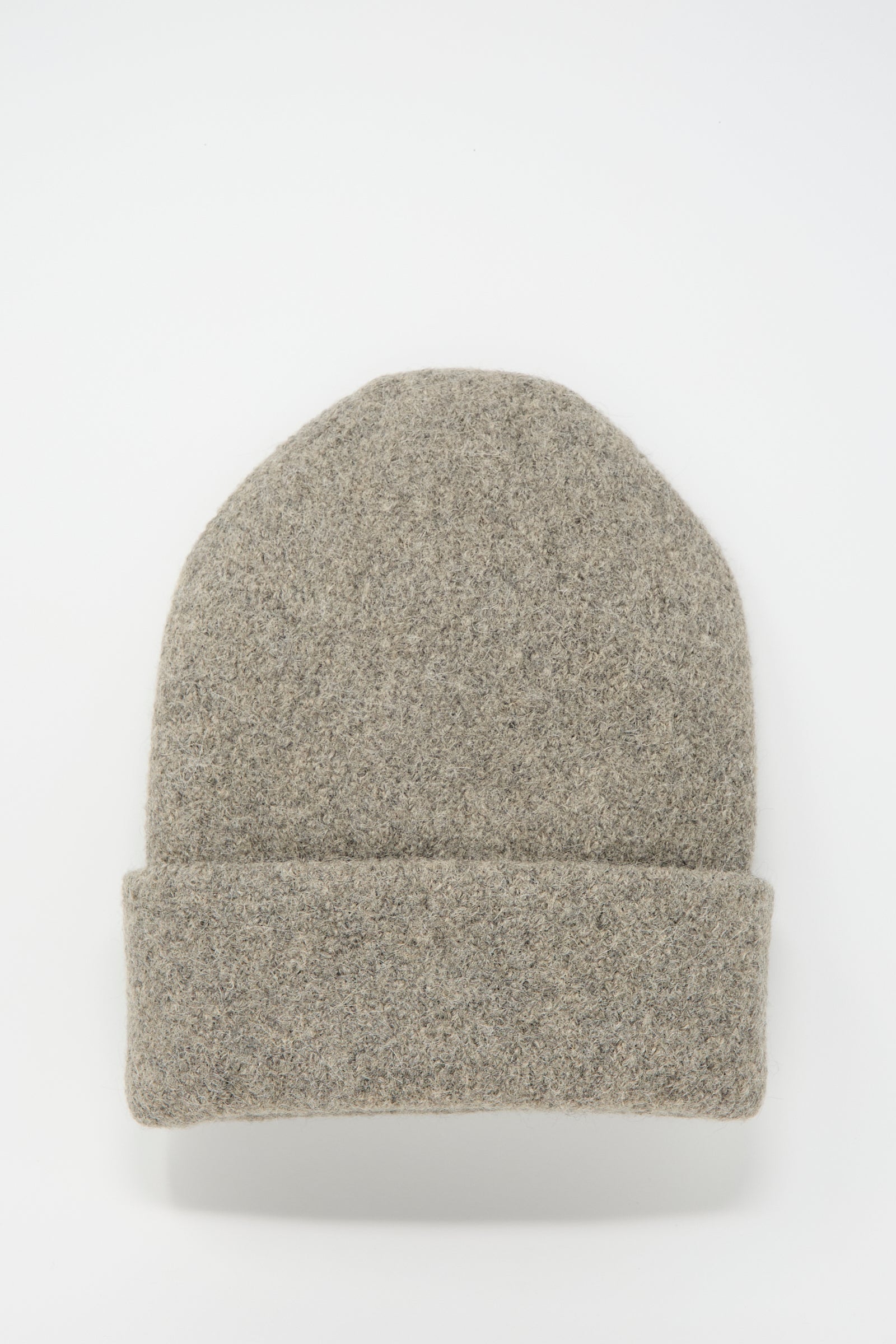 A Carpenter Hat in Rock by Lauren Manoogian, featuring a gray wool alpaca texture and a folded brim, handloomed and made in Peru, laid flat on a white background.