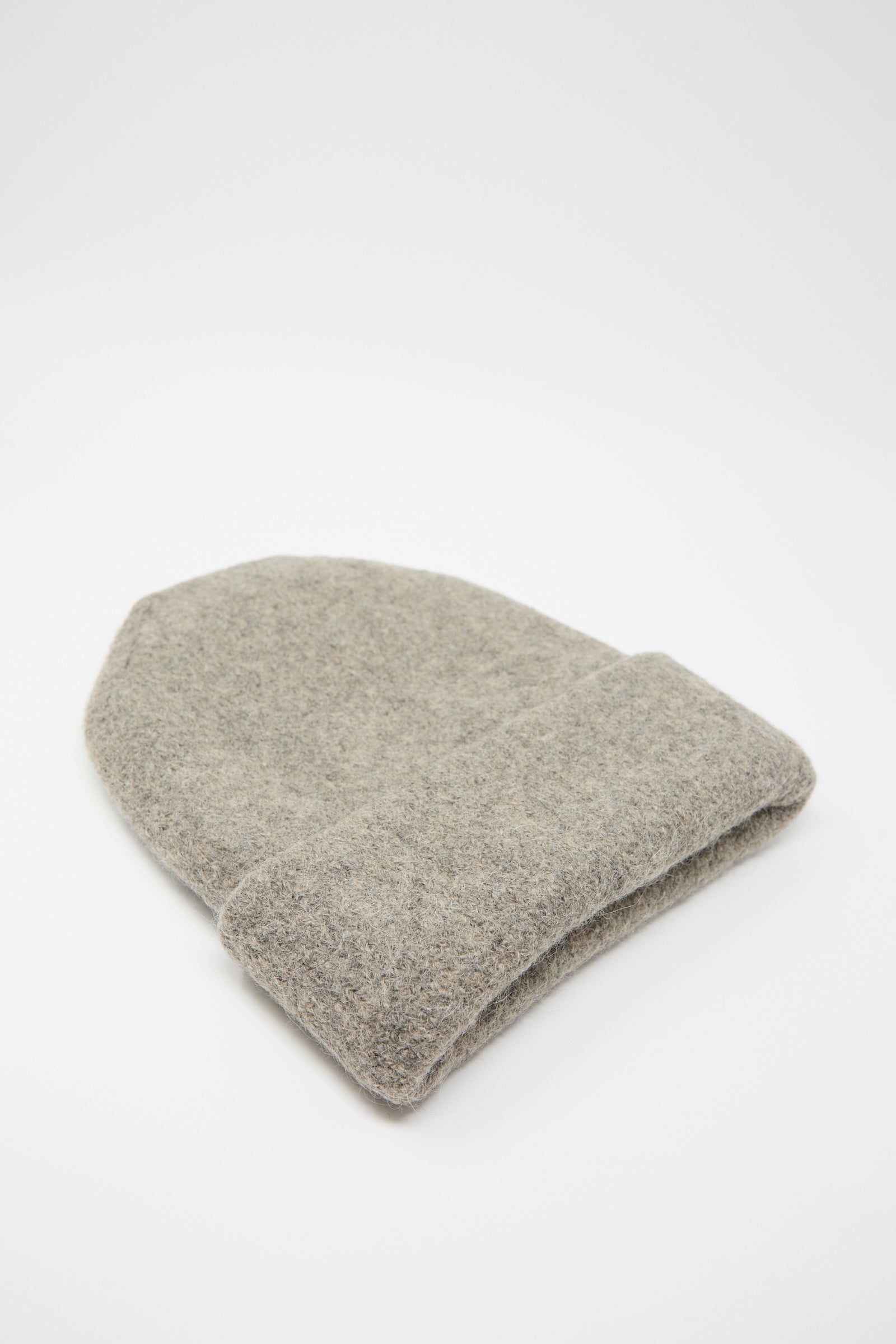 A Lauren Manoogian Carpenter Hat in Rock, handloomed and felted in gray, is placed on a plain white background.