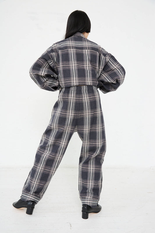 Person wearing the Lauren Manoogian Cotton Cuff Pant in Plaid stands with their back to the camera, hands on hips, against a plain white background.