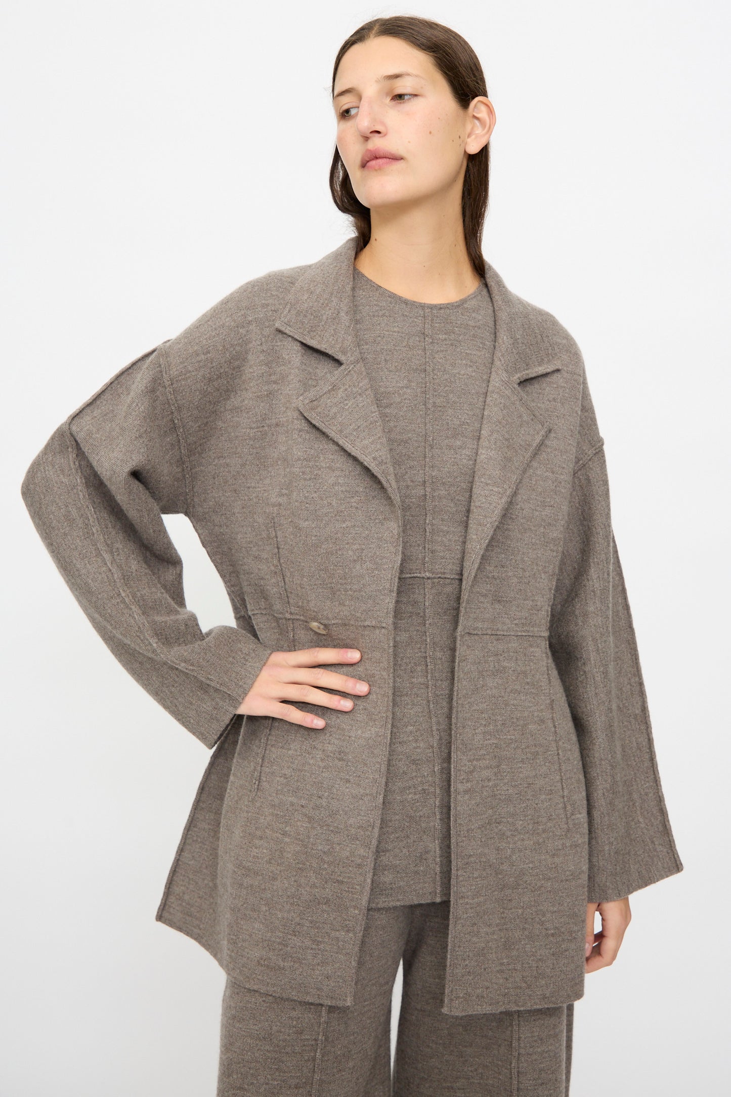 A woman wears the Lauren Manoogian Double Knit Blazer in Cinder over a matching top and pants, standing against a plain light background.