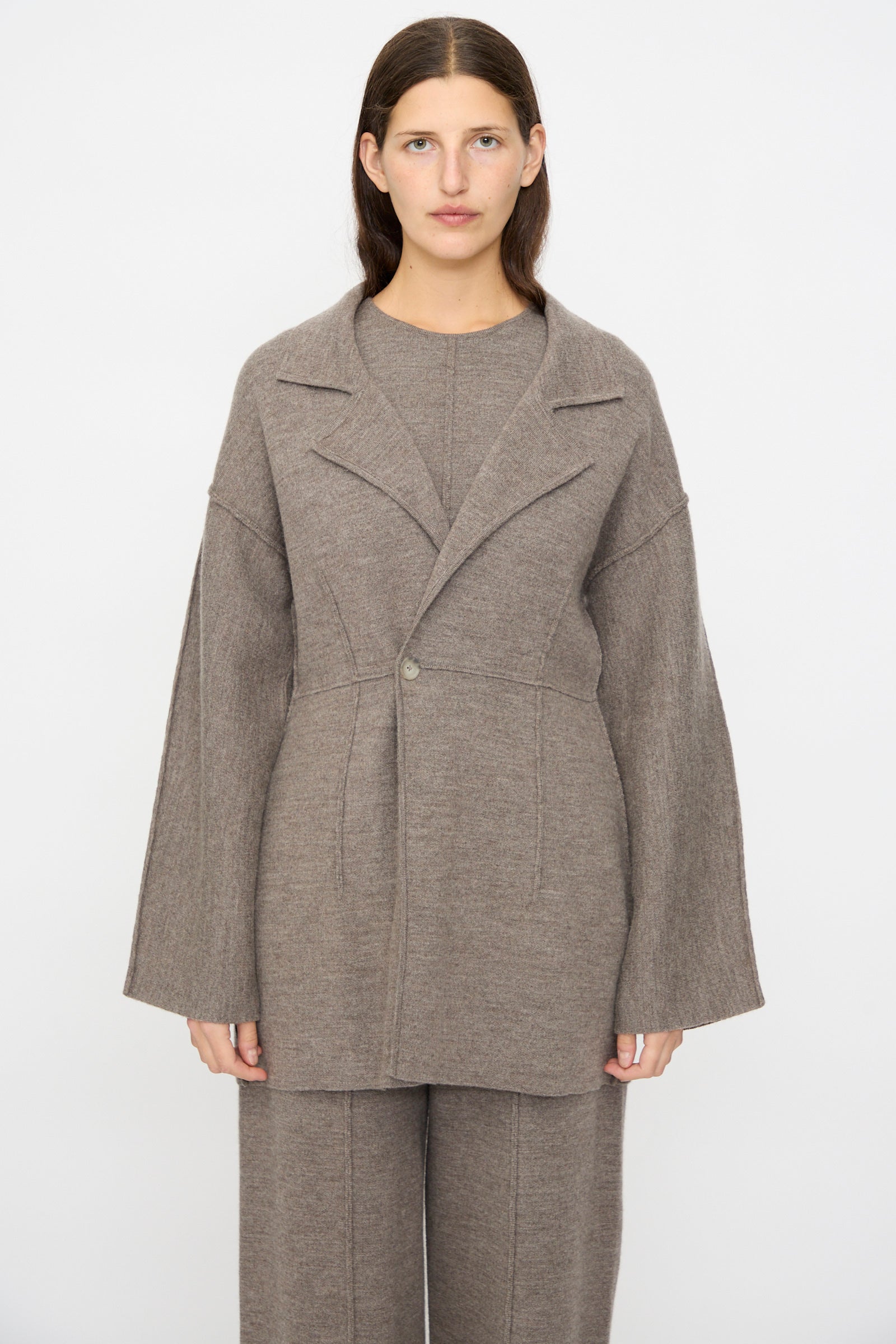 A woman faces forward wearing the Lauren Manoogian Double Knit Blazer in Cinder with matching wide-leg pants, set against a plain white background.