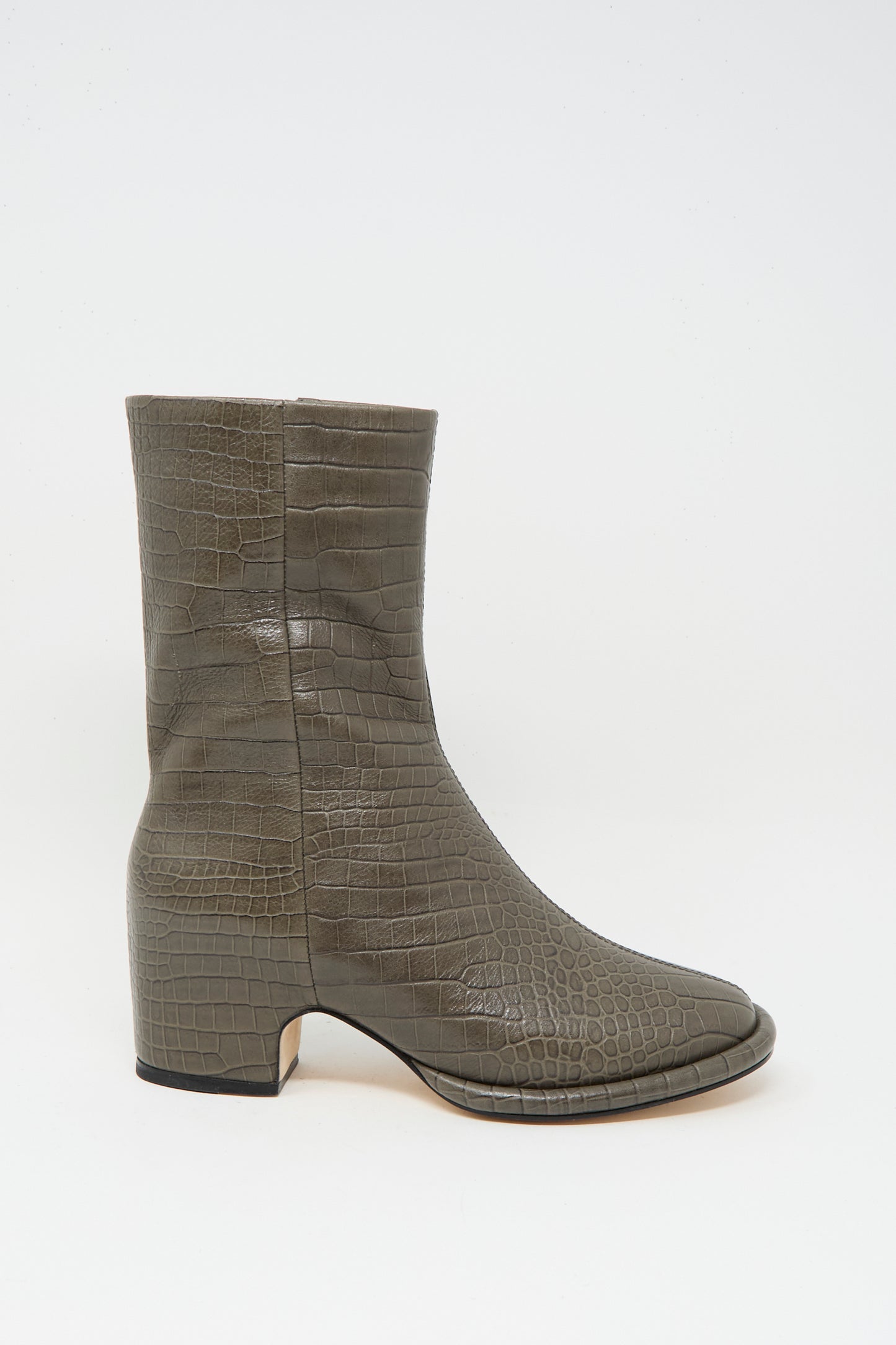 The Lauren Manoogian Embossed Arch Boot in Coal is a single olive-green, above-ankle boot with faux crocodile texture, rounded square toe, and low block heel, handmade in Peru and shown against a plain white background.