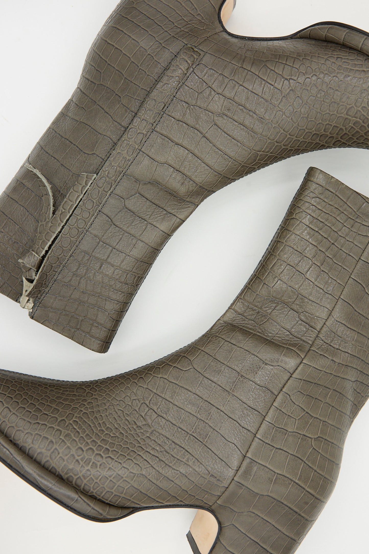 Two Embossed Arch Boots in Coal by Lauren Manoogian, featuring a crocodile-embossed texture, vegetable-tanned leather, and side zippers, are shown from the side on a white background.