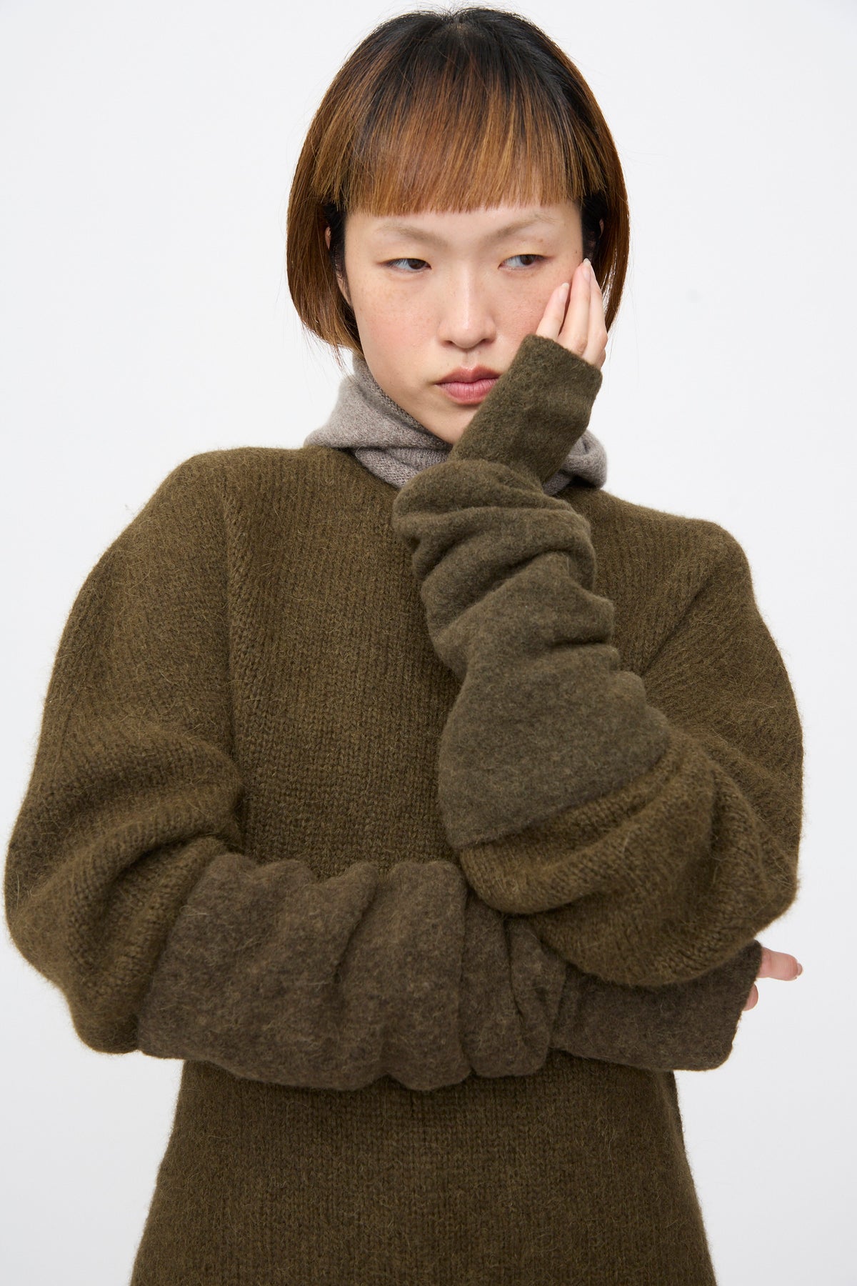 Lauren Manoogian Felt Fingerless Gloves in Olive, elbow-length and felted, scrunched to the forearm.