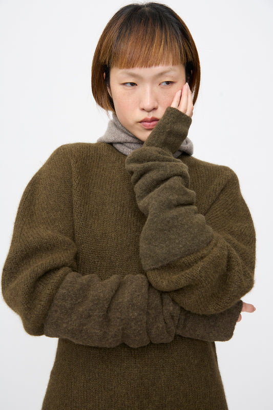 Lauren Manoogian Felt Fingerless Gloves in Olive, elbow-length and felted, scrunched to the forearm.