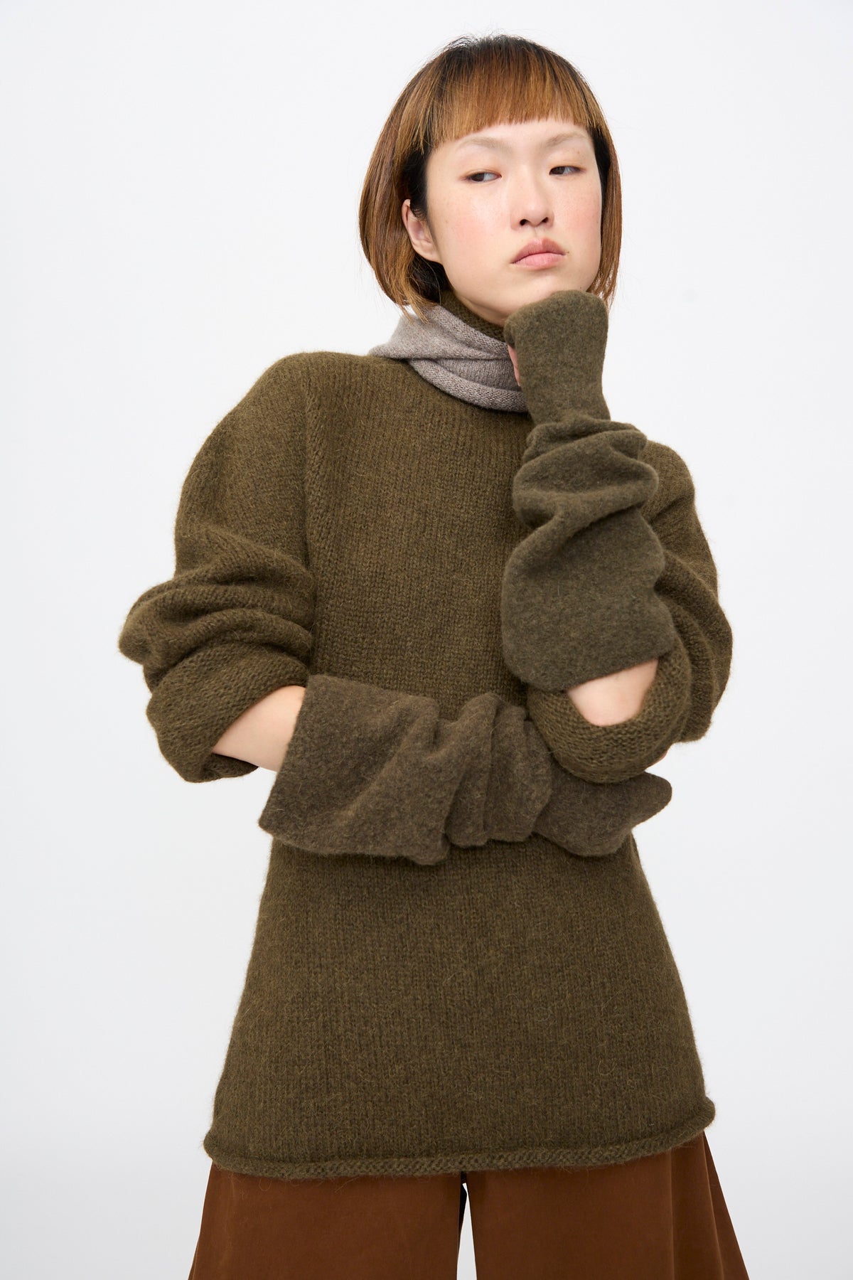 Lauren Manoogian Felt Fingerless Gloves in Olive, elbow-length gloves worn scrunched to the forearm.