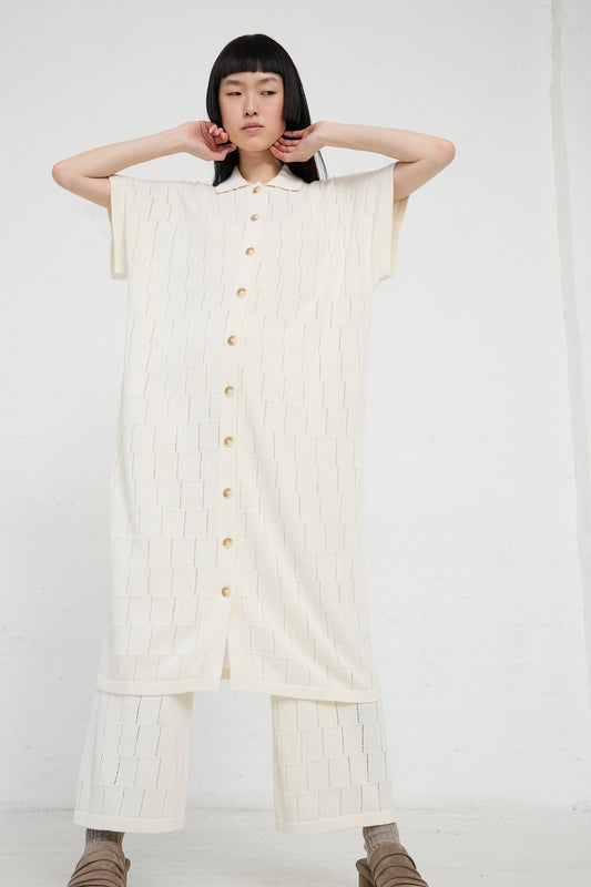 A woman in a Lauren Manoogian Lattice Shirt Dress in Bone posing against a white background.