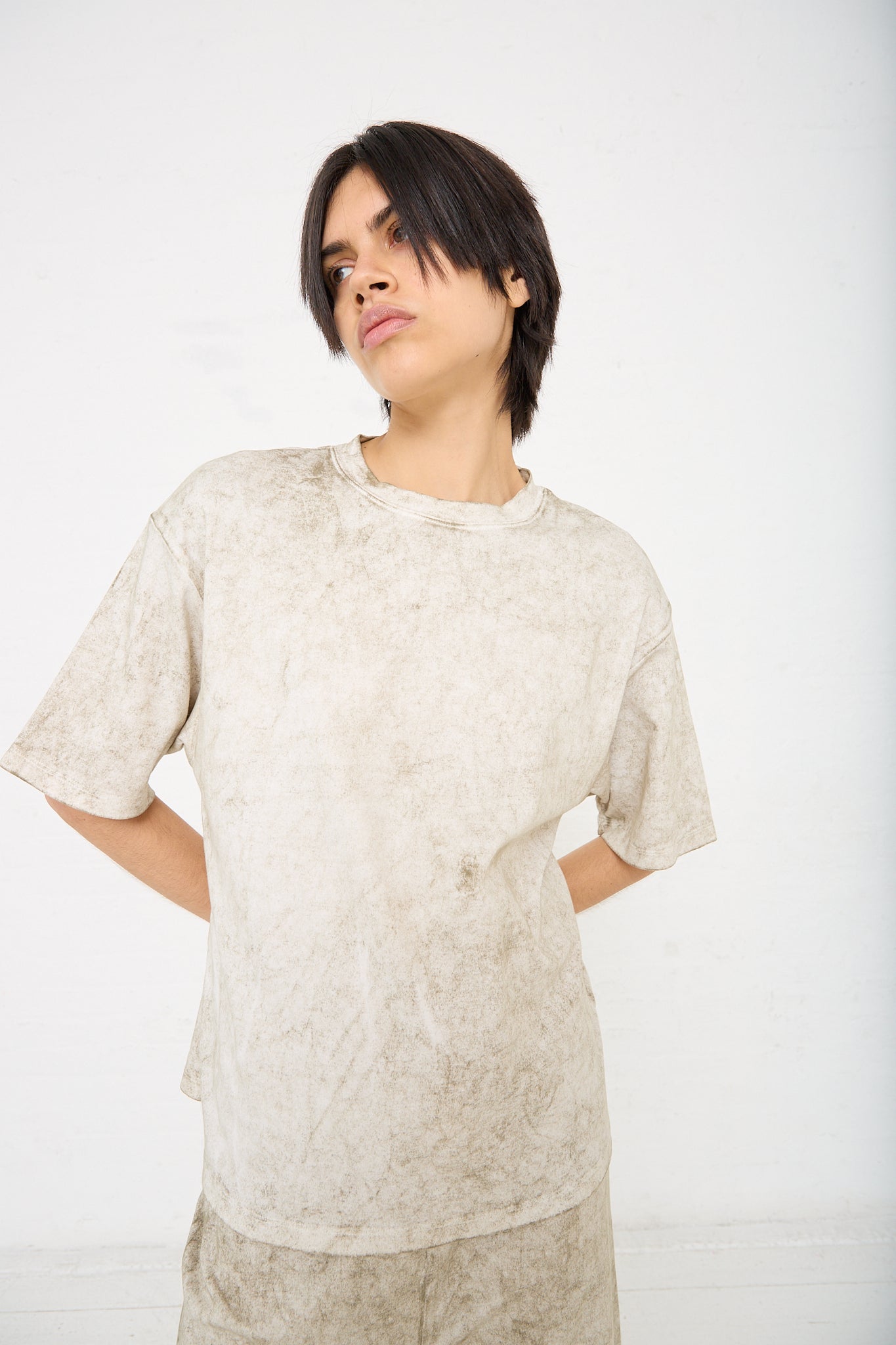 The model is wearing an oversized Pima Cotton Lunar Tee in Olive with a boxy silhouette by Lauren Manoogian. Front view.