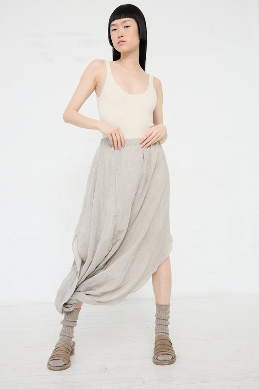 Woman in a Lauren Manoogian Rib Bodysuit in Hessian and draped maxi skirt posing against a white background.