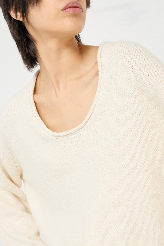 The model is wearing a Roving U Neck Sweater in Raw White by Lauren Manoogian.