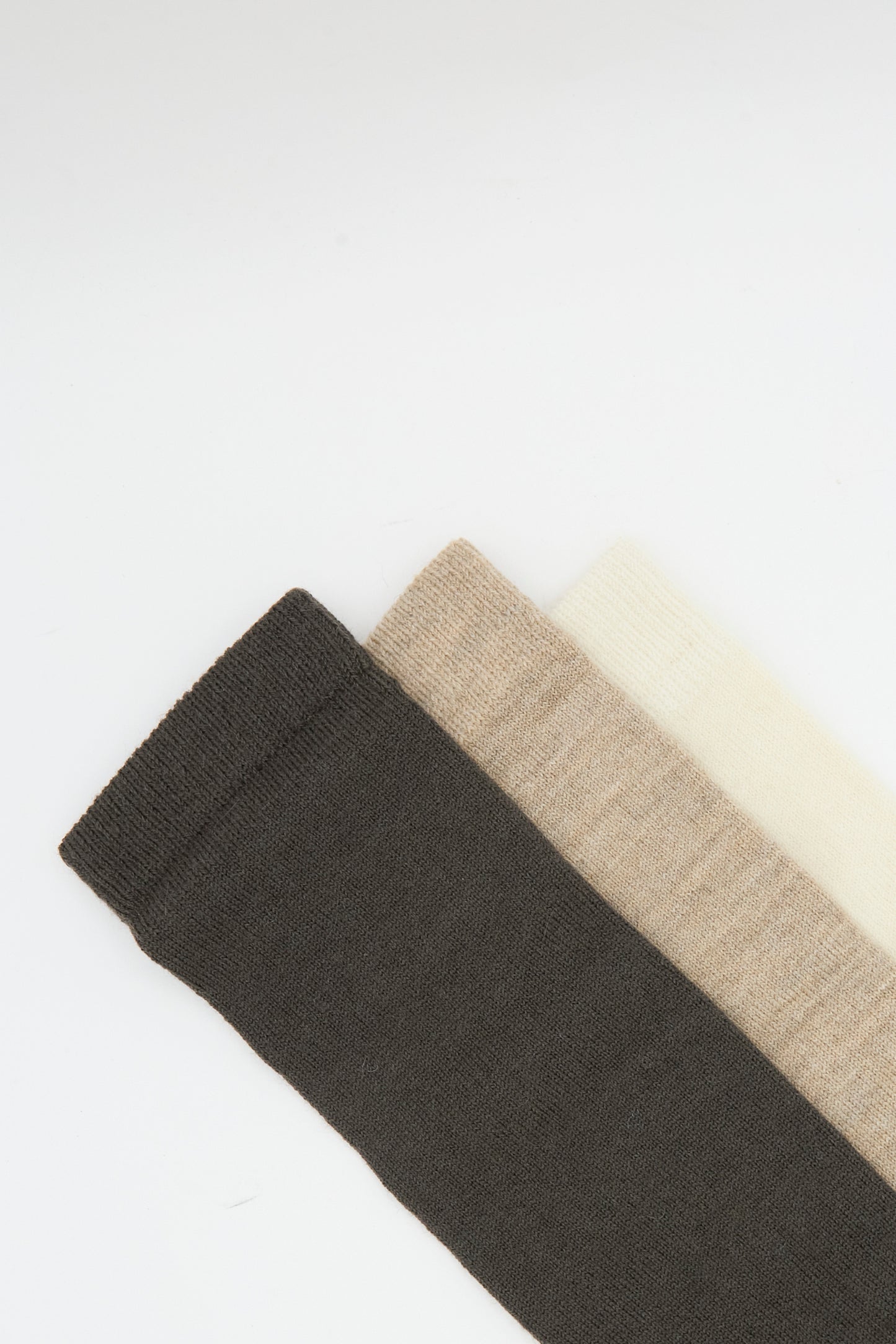 Three pairs of Lauren Manoogian Sock Set in Mix—dark brown, beige, and off-white—are arranged side by side on a white background. 