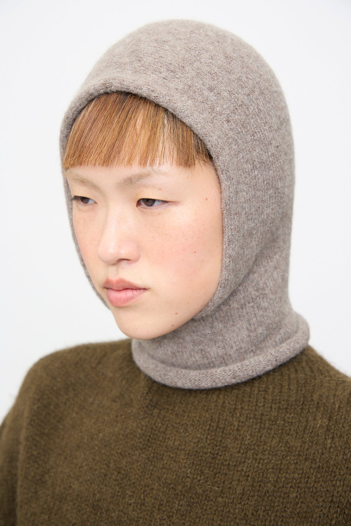 A person wearing a grey handloomed Soft Balaclava in Grey Melange by Lauren Manoogian.