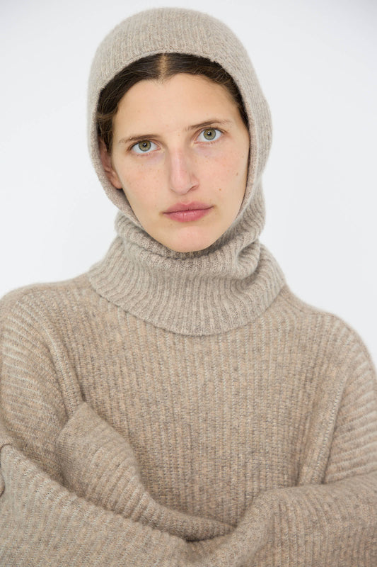 A person wearing the Soft Rib Balaclava in Dust by Lauren Manoogian, looking directly at the camera against a plain background.