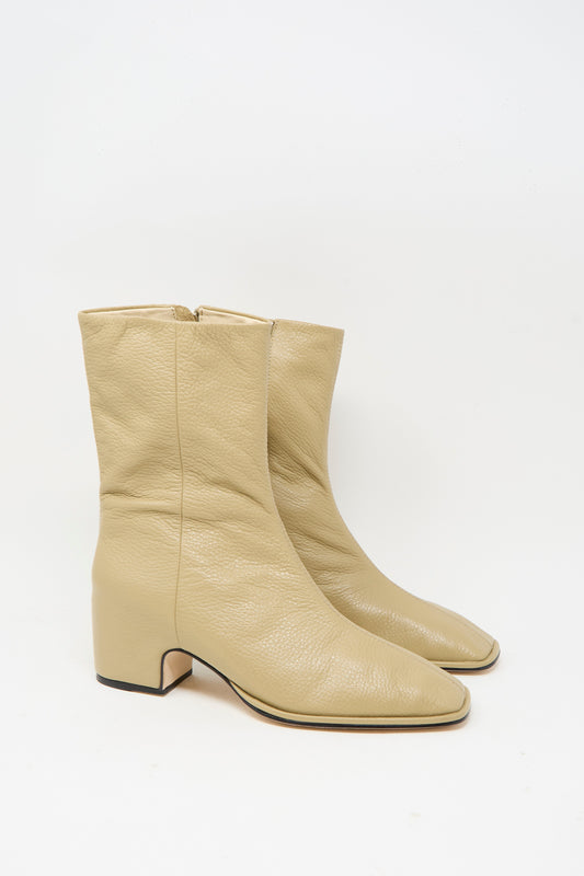 The Square Arch Boot in Beige by Lauren Manoogian is a pair of mid-calf boots made from vegetable tanned leather, featuring a square toe, block heel, and durable leather sole, shown against a white background.