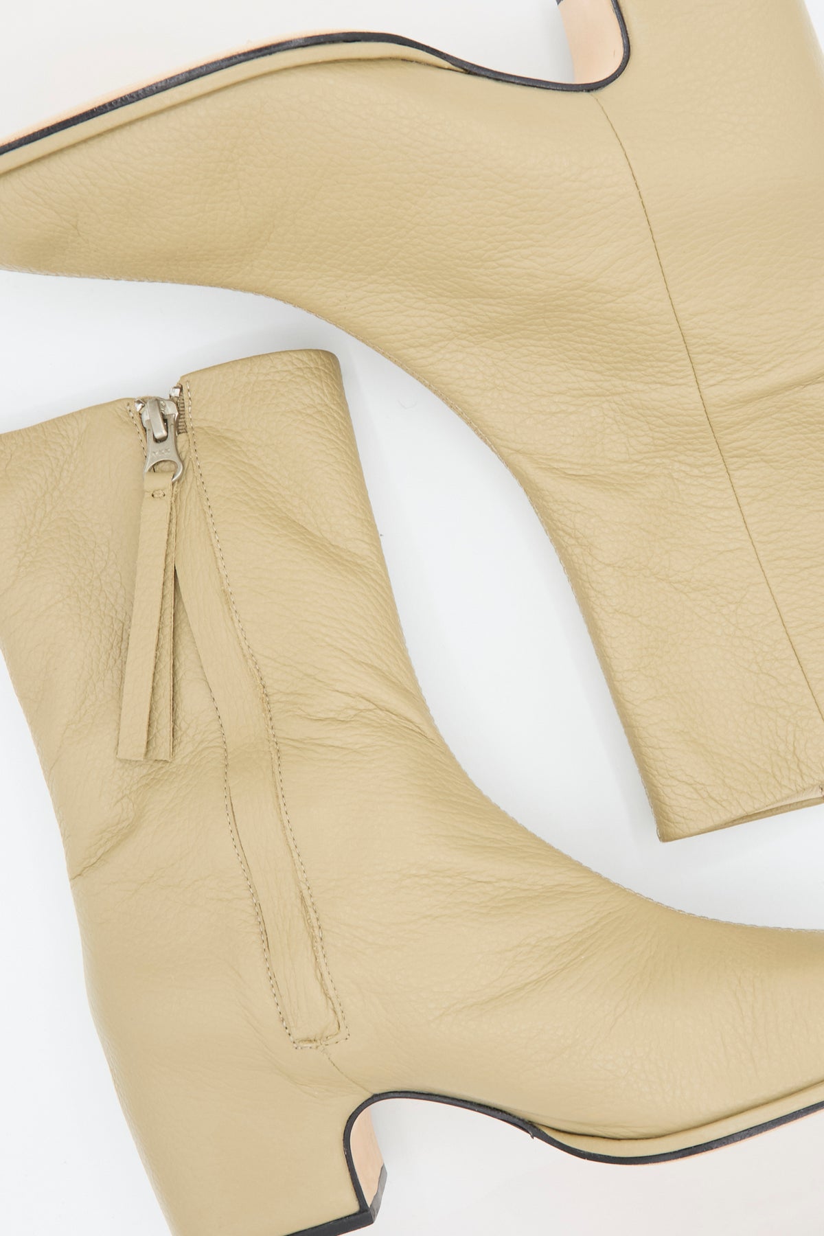 A pair of Lauren Manoogian Square Arch Boots in Beige, crafted from vegetable-tanned leather with side zippers and block heels, photographed from above on a white background. These boots feature a durable leather sole for enhanced comfort and longevity.