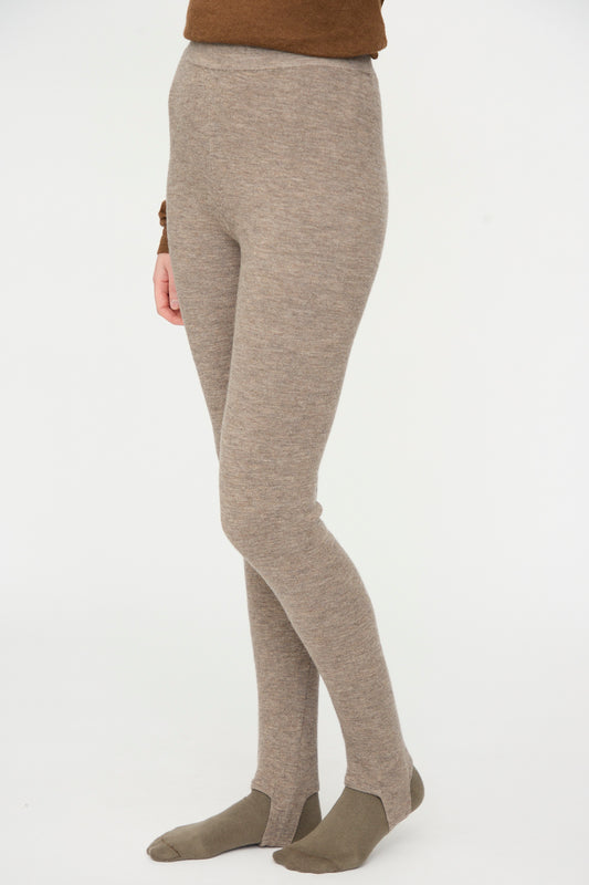 Person wearing Lauren Manoogian Stirrup Legging in Grey Melange with brown socks, standing against a plain white background.