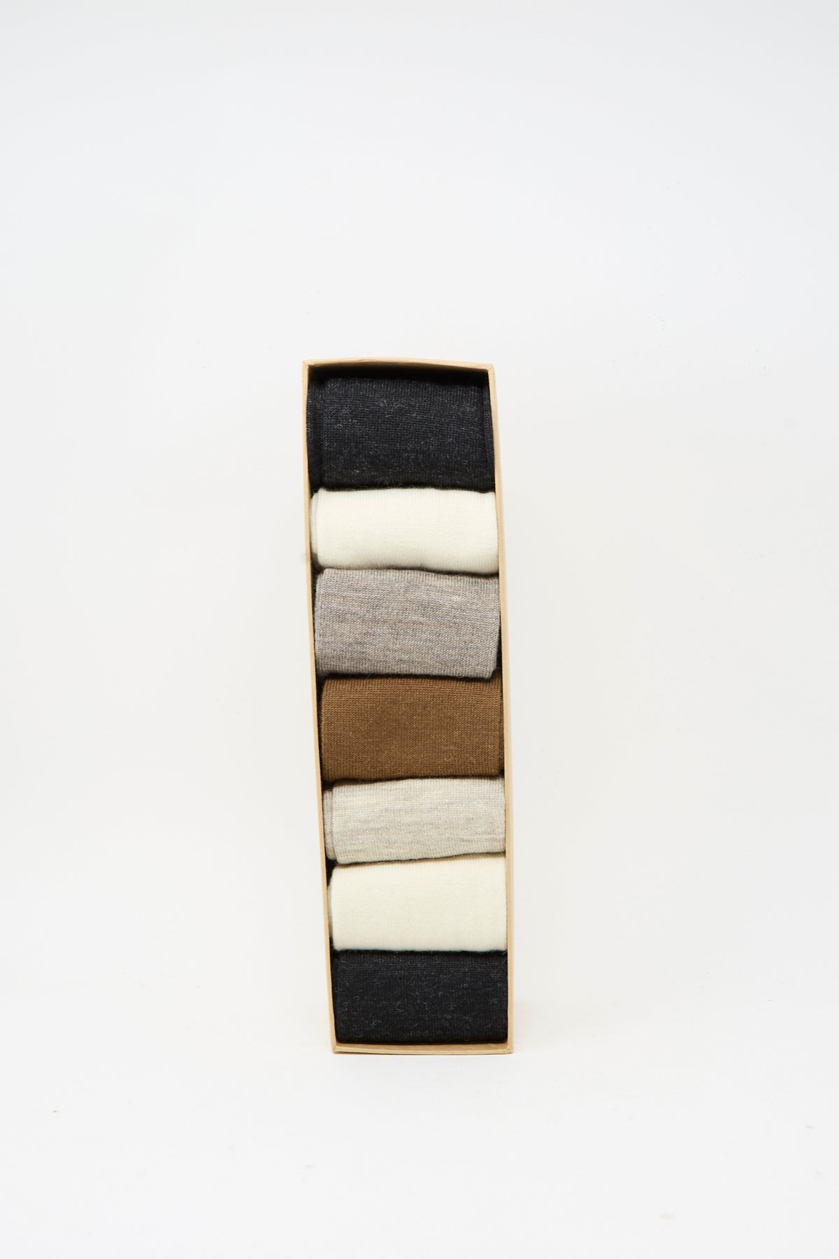 A rectangular box of the Lauren Manoogian Tall Sock Set in Mix, featuring six pairs of neatly folded merino wool socks in assorted neutral colors—black, white, brown, and beige—displayed against a white background.