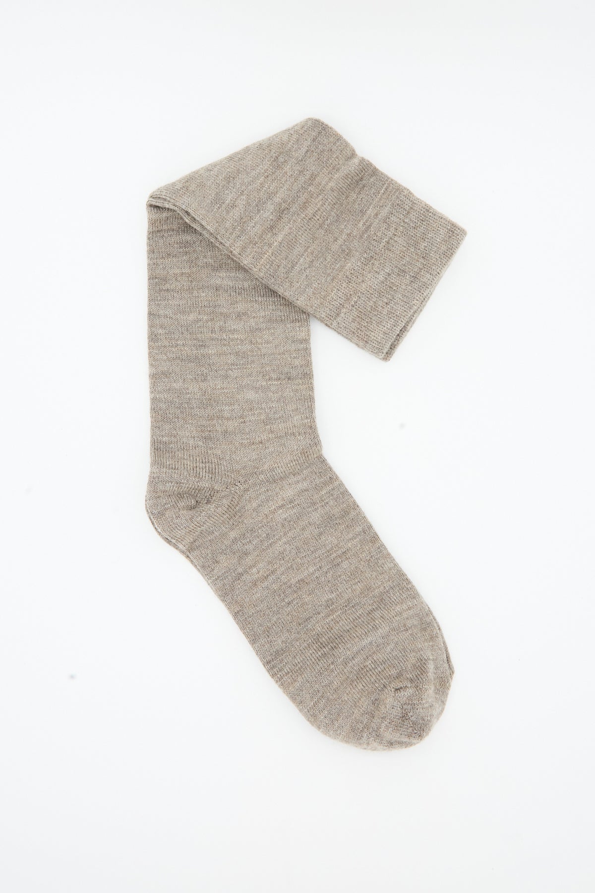 A single light brown sock from the Lauren Manoogian Tall Sock Set in Mix, crafted from merino wool in Peru, is laid flat on a white background with its top folded over near the cuff.