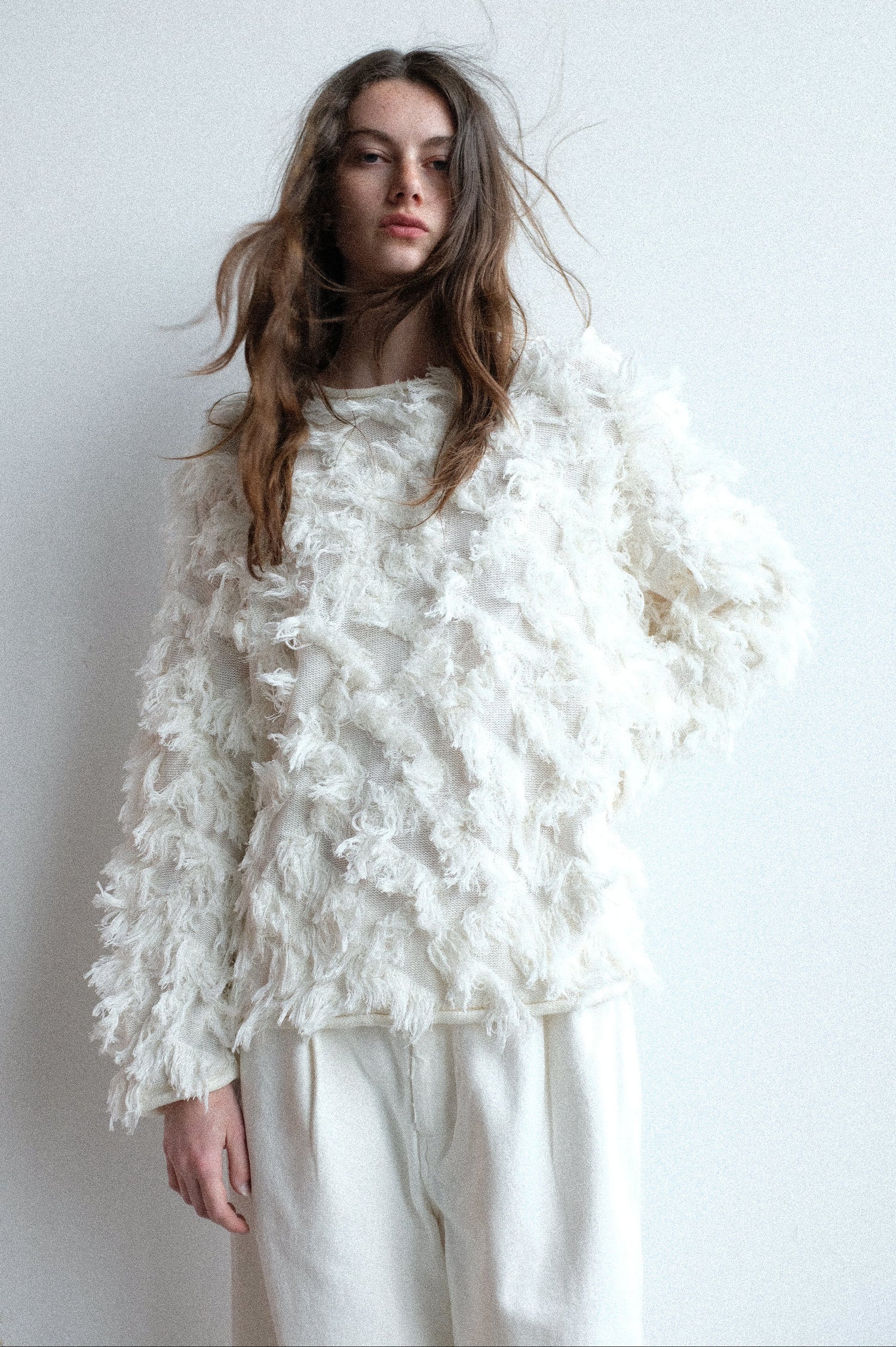 Woman wearing Lauren Manoogian's Tufted Pullover in Bone against a plain background.