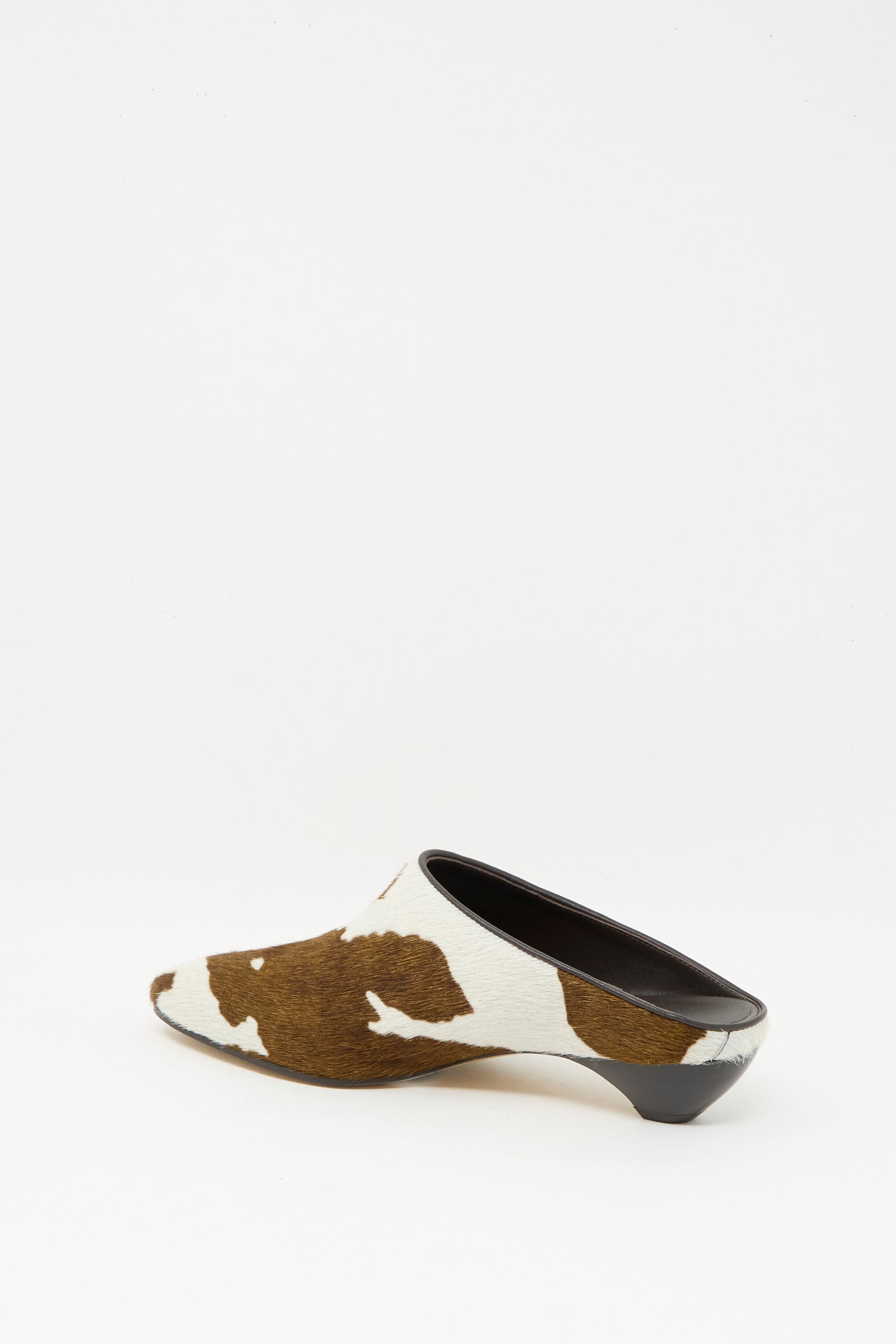 The Allegra Mule in Cow by Le Monde Beryl features brown and white calf hair leather with a low black heel, displayed against a plain white background.
